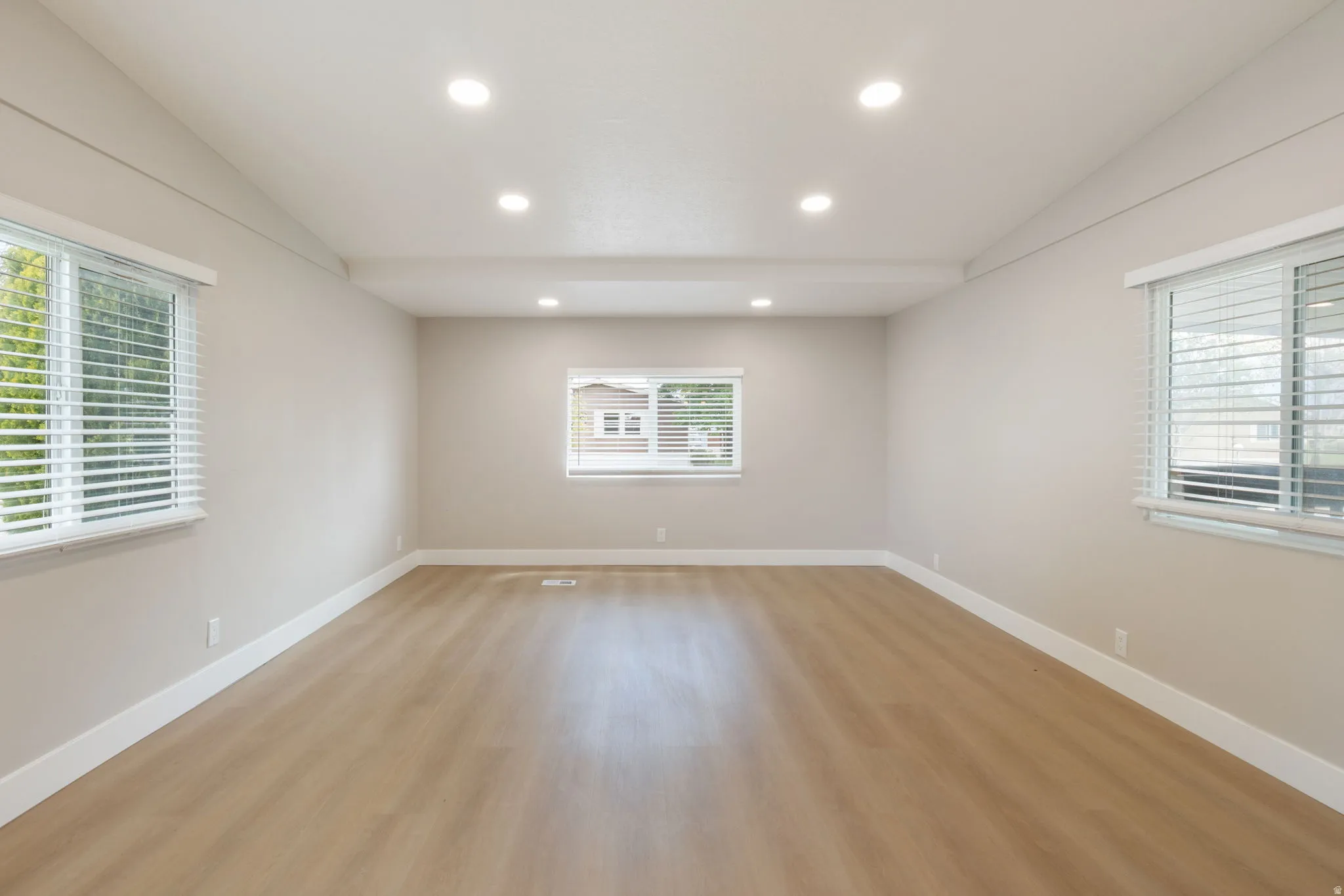 Unfurnished room with light wood finished floors and recessed lighting