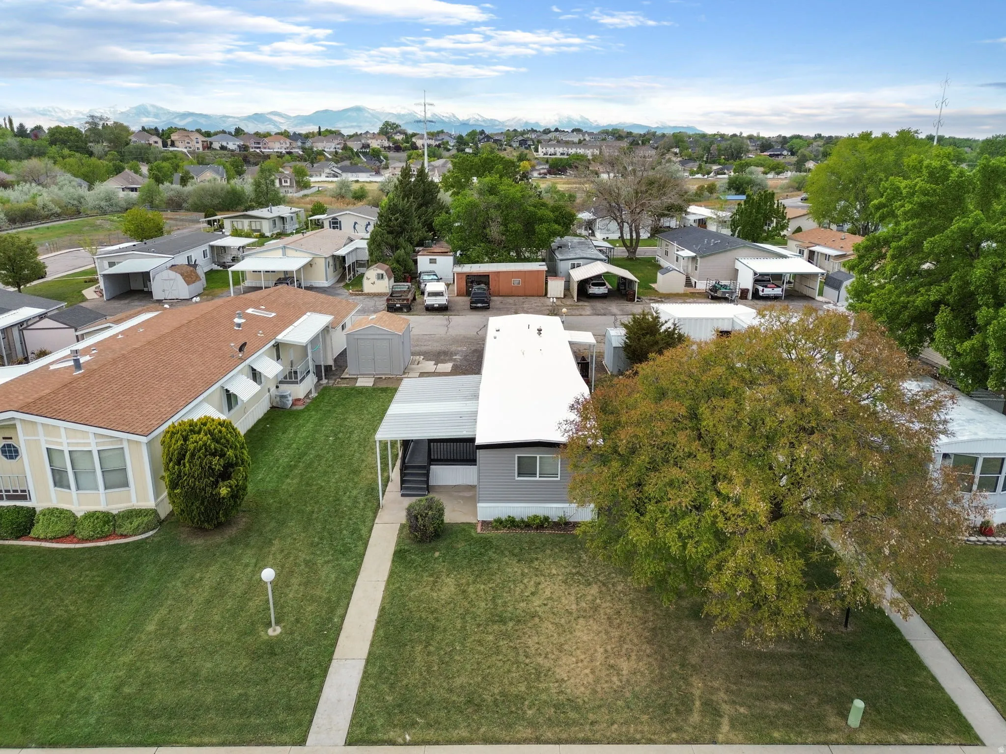 Aerial perspective of suburban area featuring a mountain backdrop