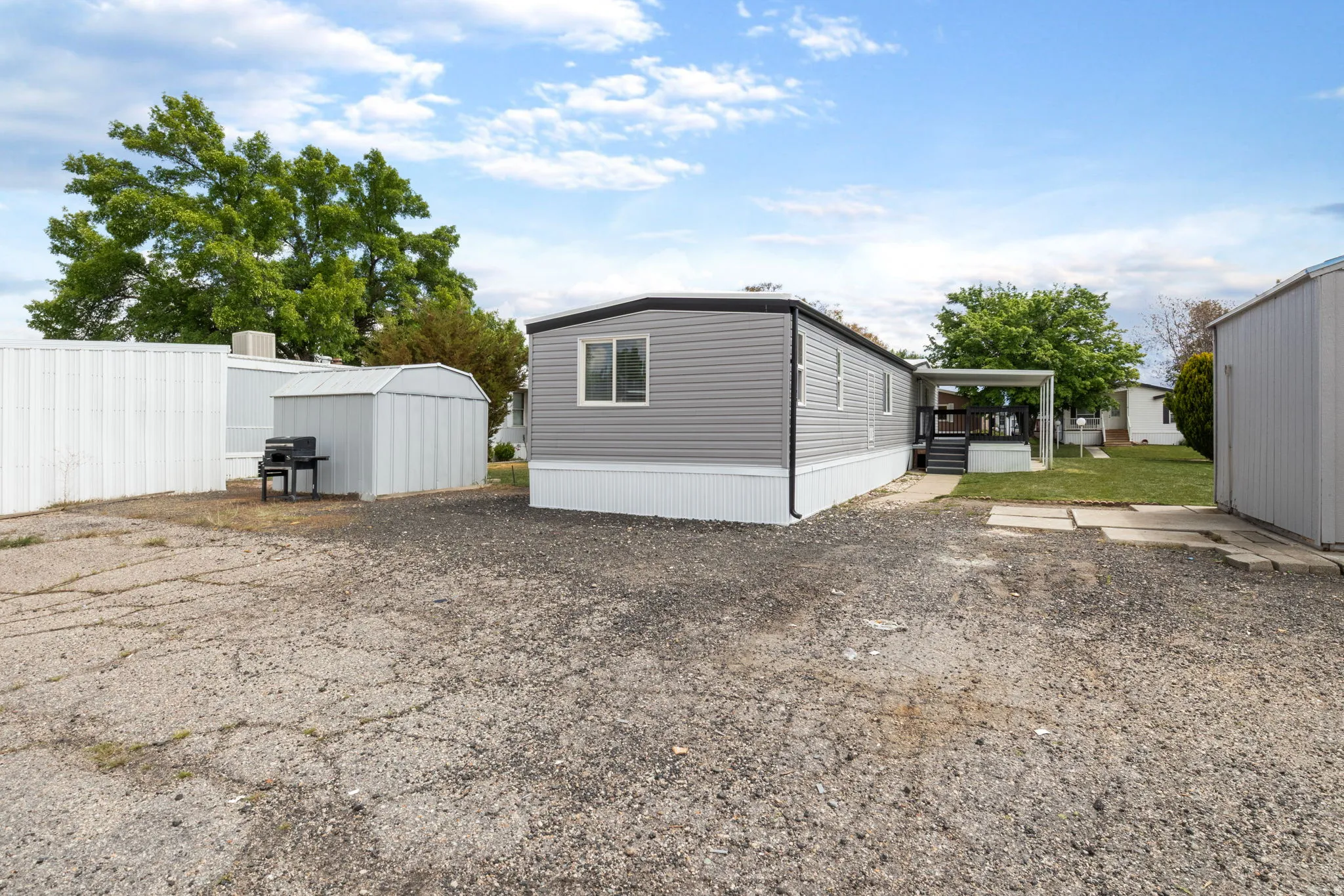 View of side of home with a storage unit