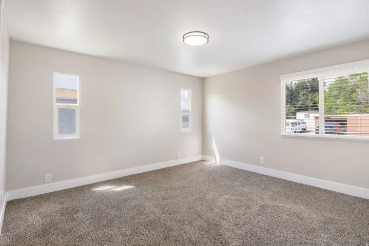 Unfurnished room with carpet floors and plenty of natural light
