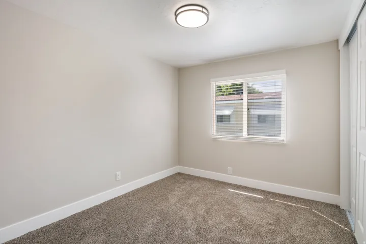 Empty room with baseboards and carpet
