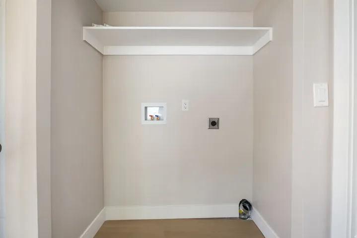 Laundry area featuring hookup for an electric dryer, wood finished floors, and washer hookup