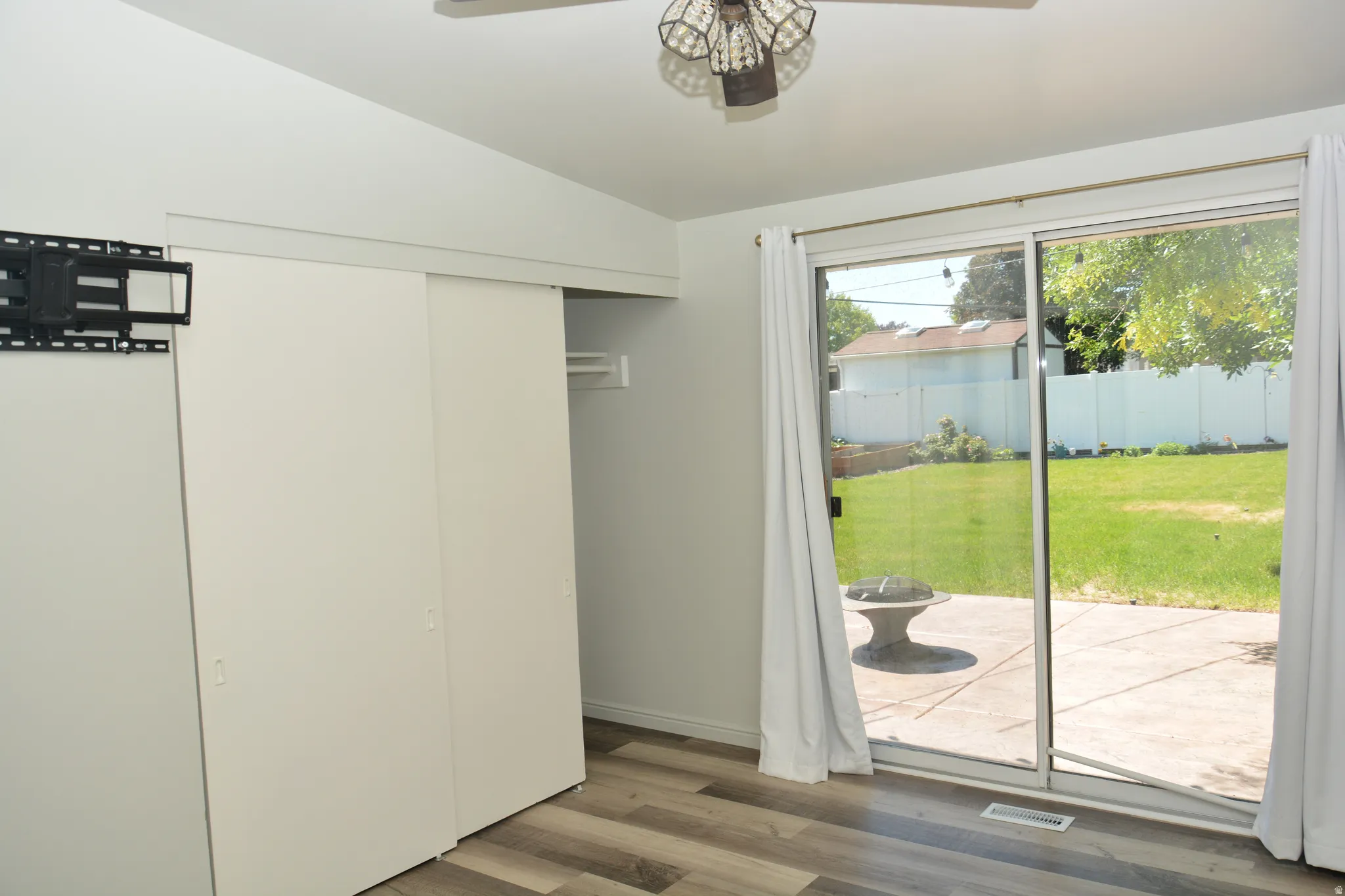 Sliding glass doors opening to an outdoor patio and grass area