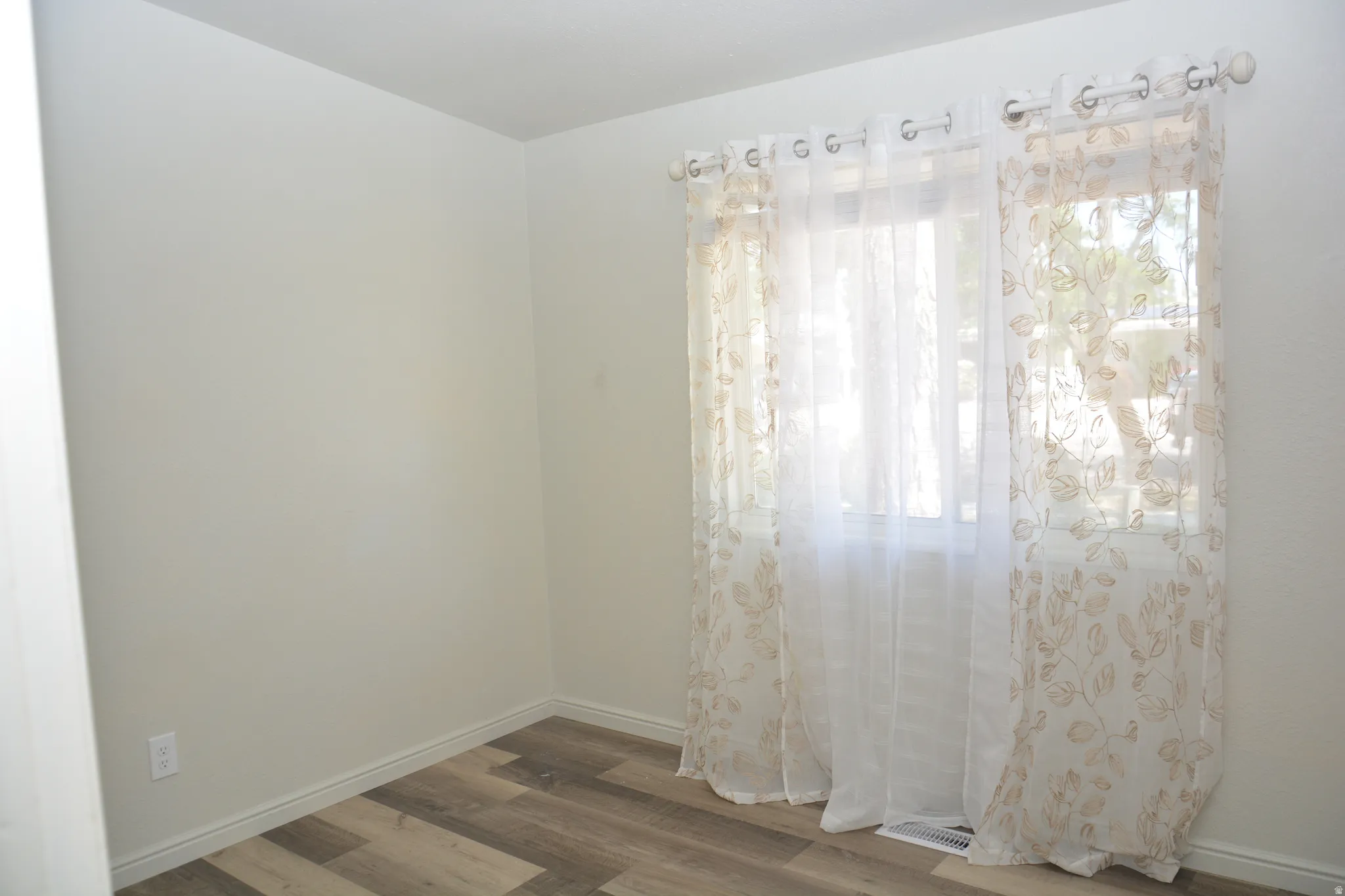 Neutral walls with wood-finish flooring