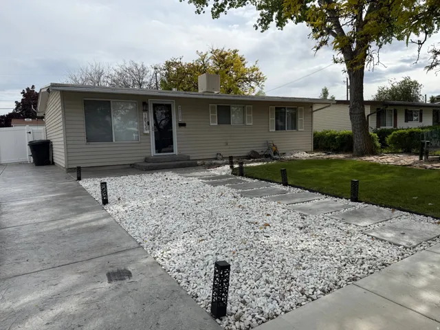 Single story home featuring a front lawn and a chimney