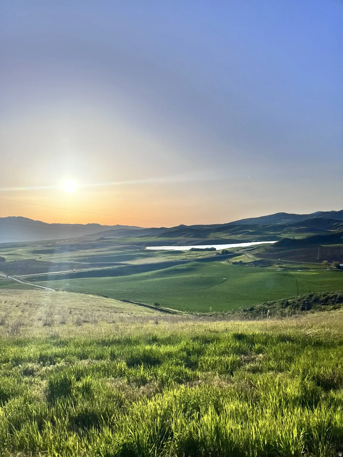 Water view with a mountainous background and rural landscape