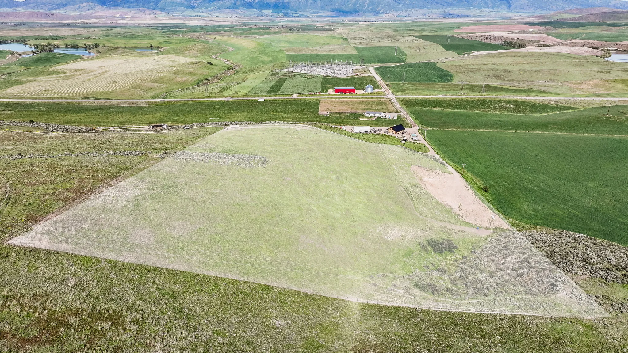 Expansive land parcel with surrounding agricultural fields