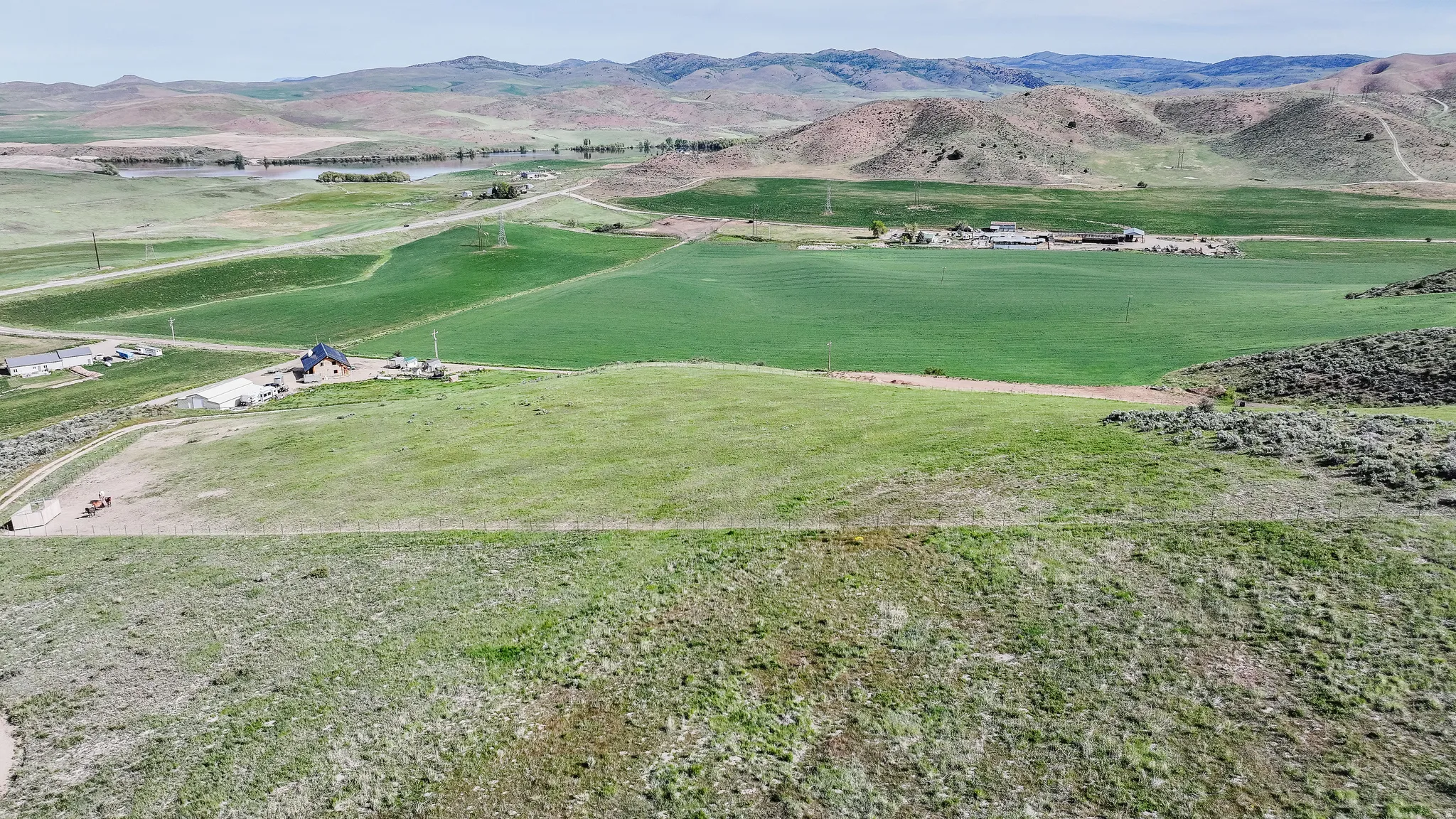 Expansive acreage featuring green fields and distant rolling hills