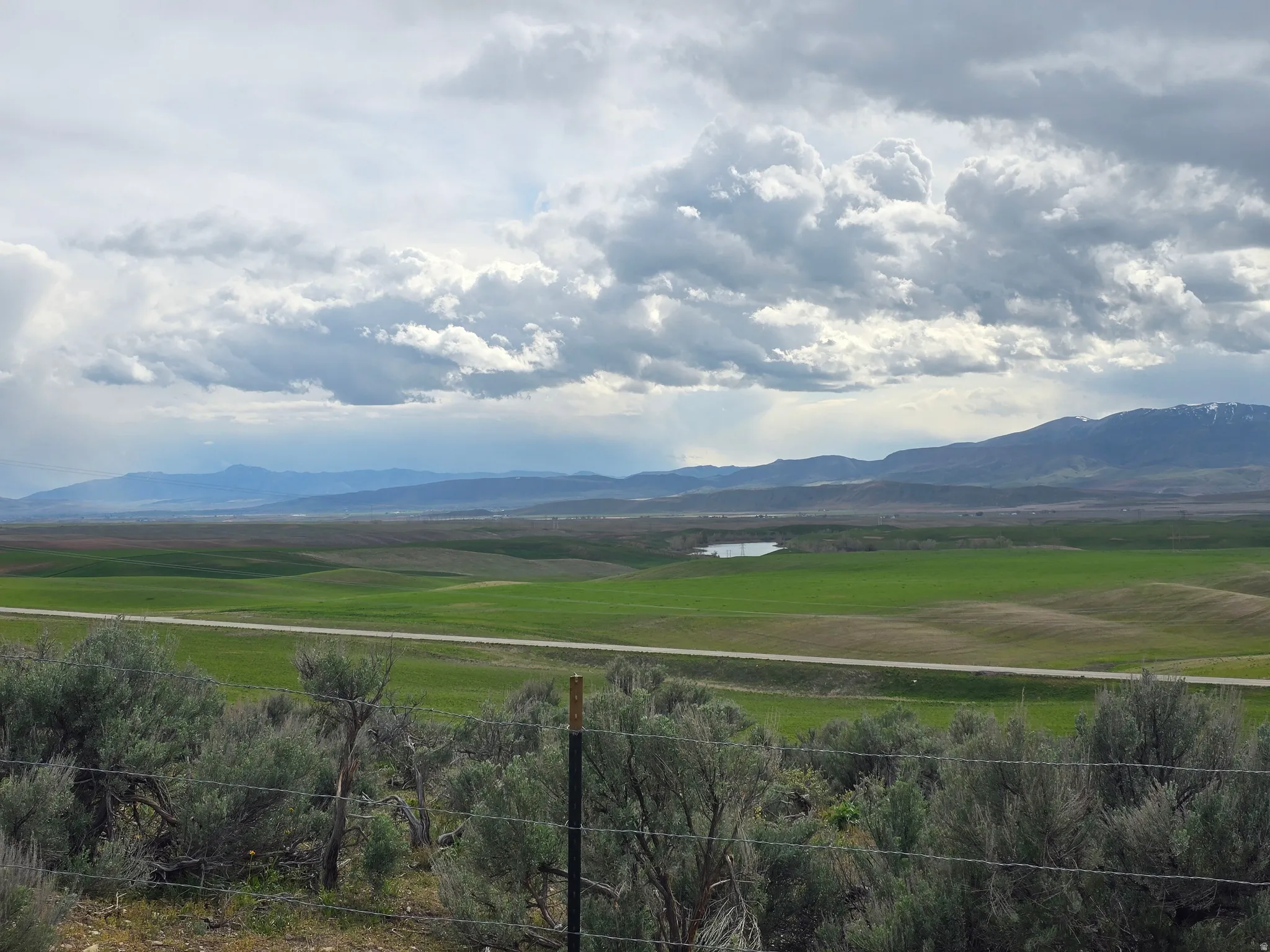 View of mountain background featuring rural landscape and a large body of water
