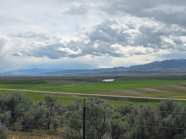 View of mountain background featuring rural landscape and a large body of water