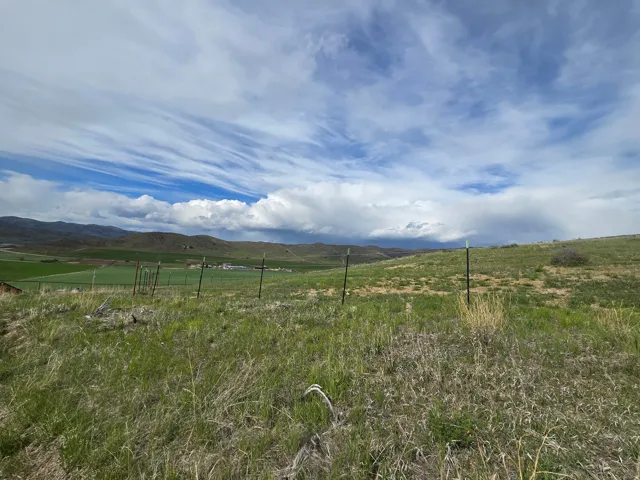 View of mountain backdrop with rural landscape