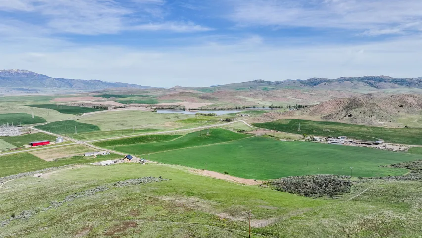 Expansive property featuring verdant fields and distant mountains
