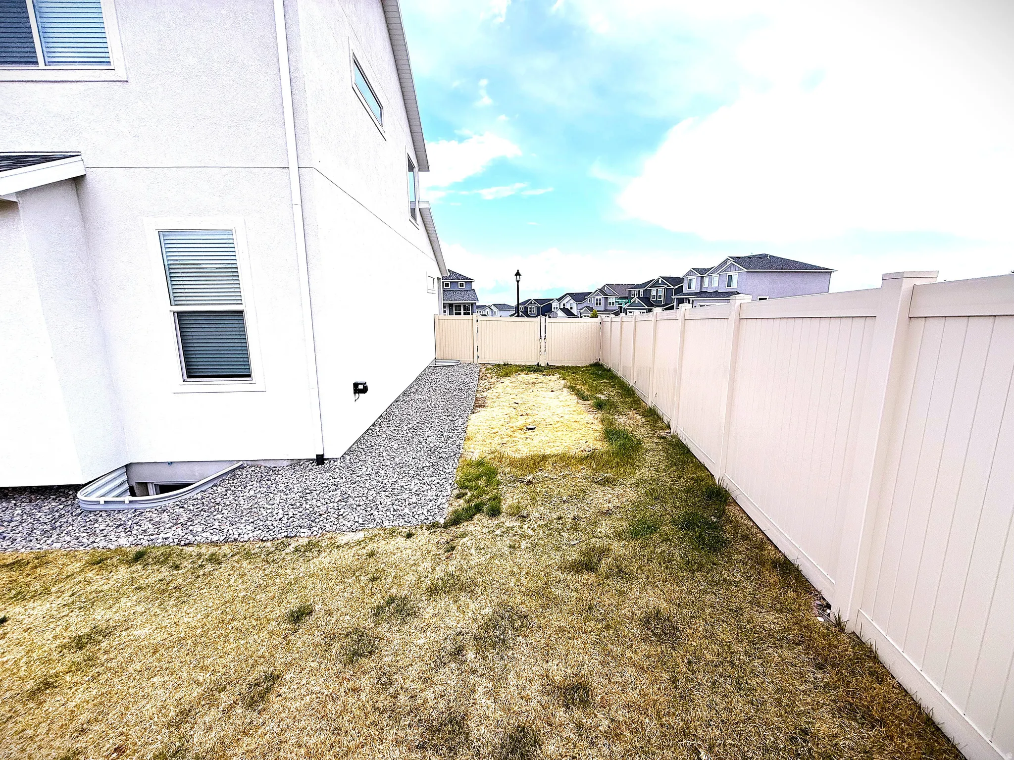 Fenced backyard with a residential view