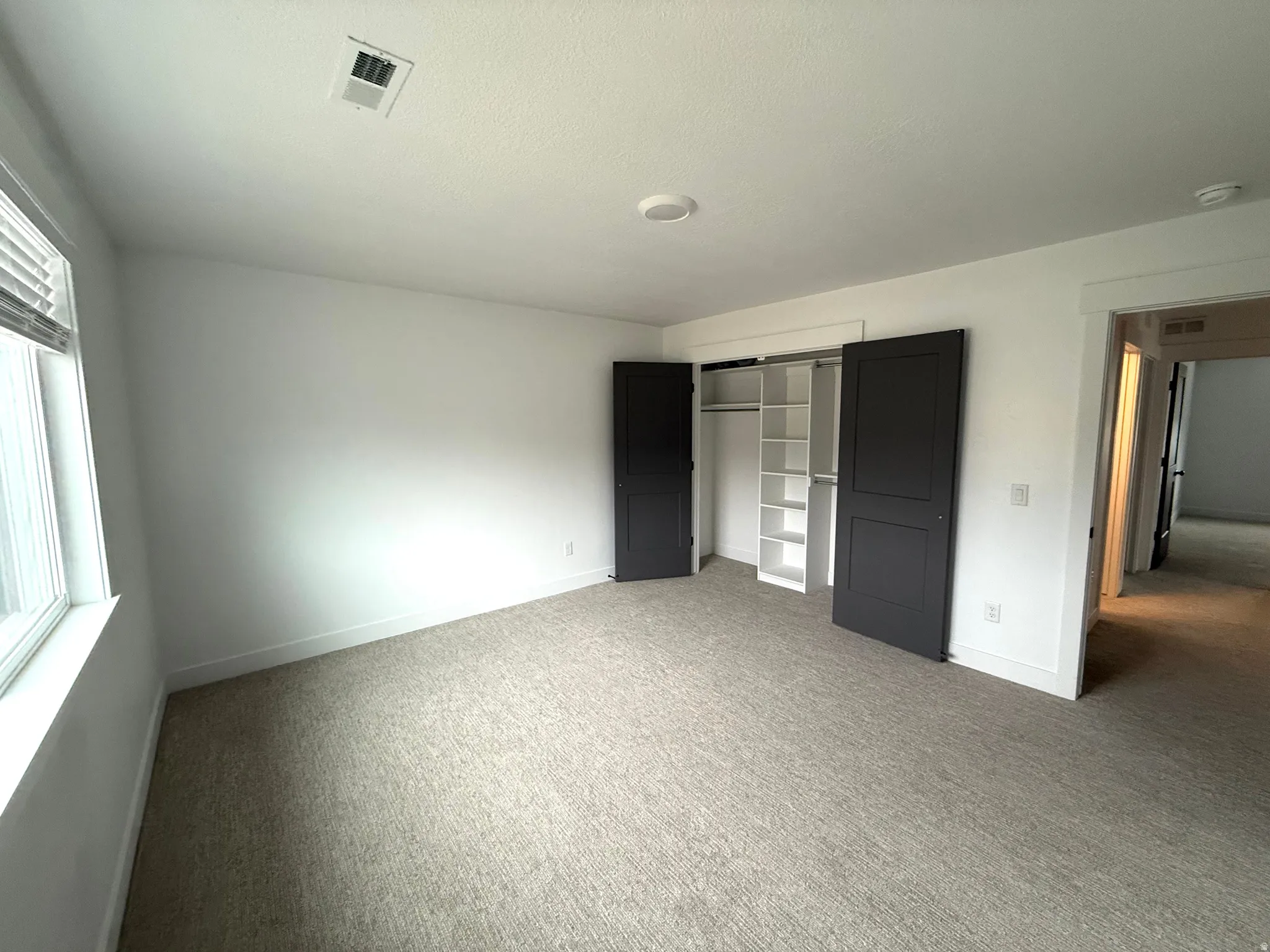 Unfurnished bedroom with a closet and carpet floors