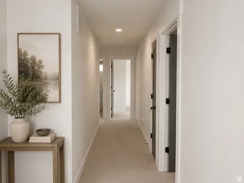 Hallway featuring neutral carpet, white walls, and recessed lighting