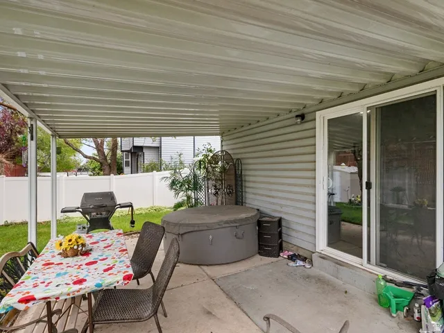 View of patio featuring area for grilling and outdoor dining area