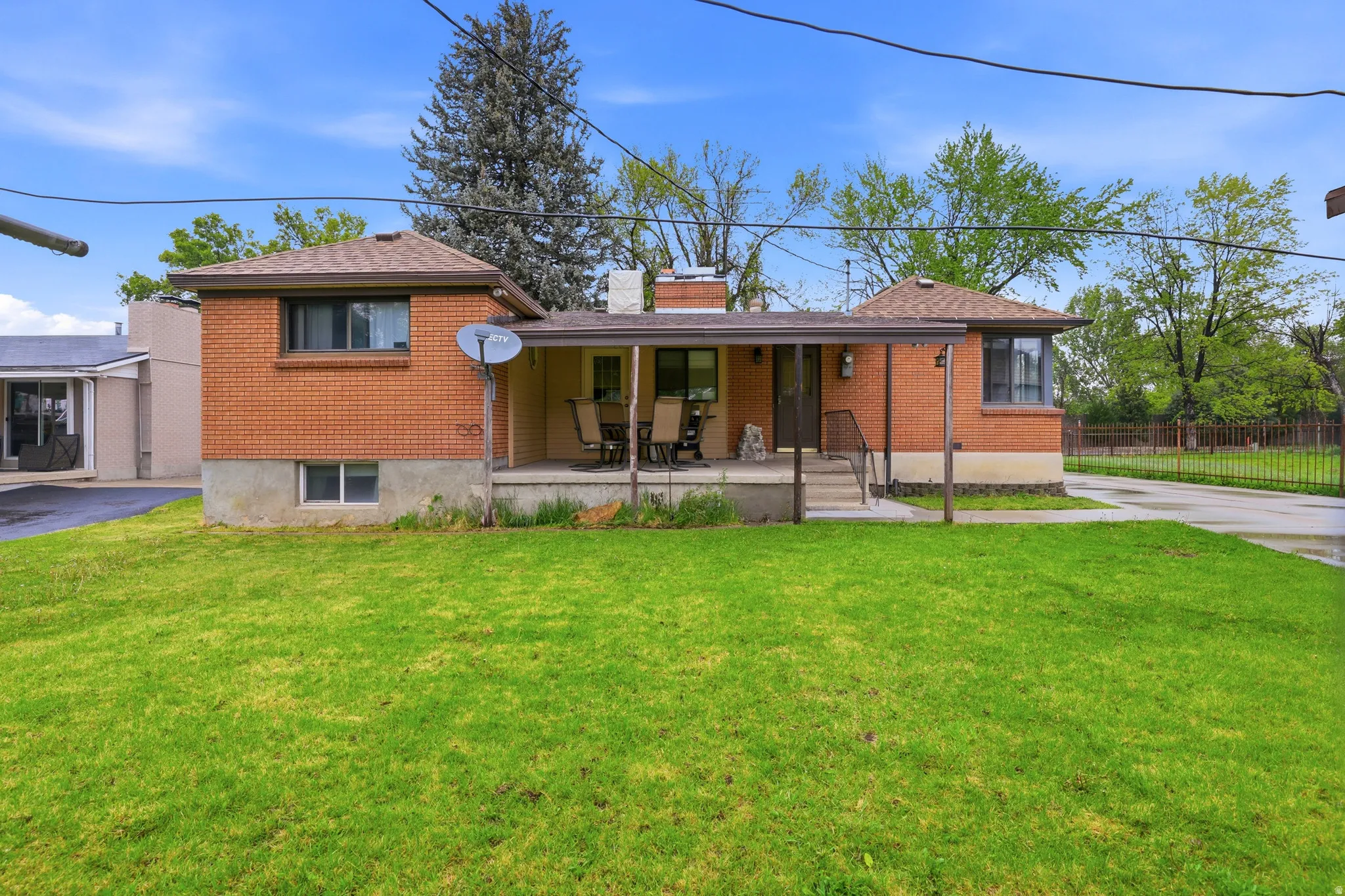 Bungalow with brick siding, covered porch, and a chimney