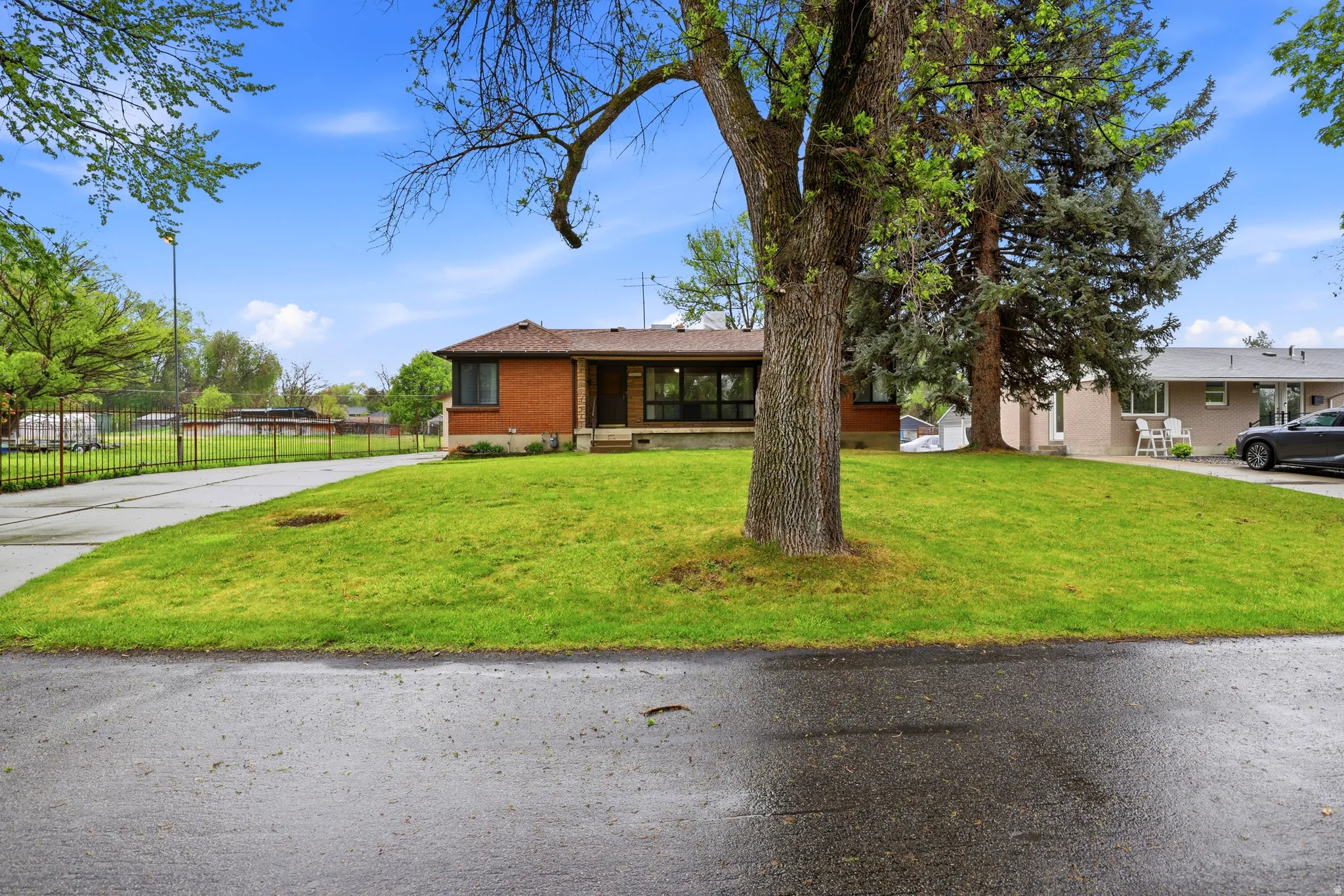 View of front of property with brick siding and driveway