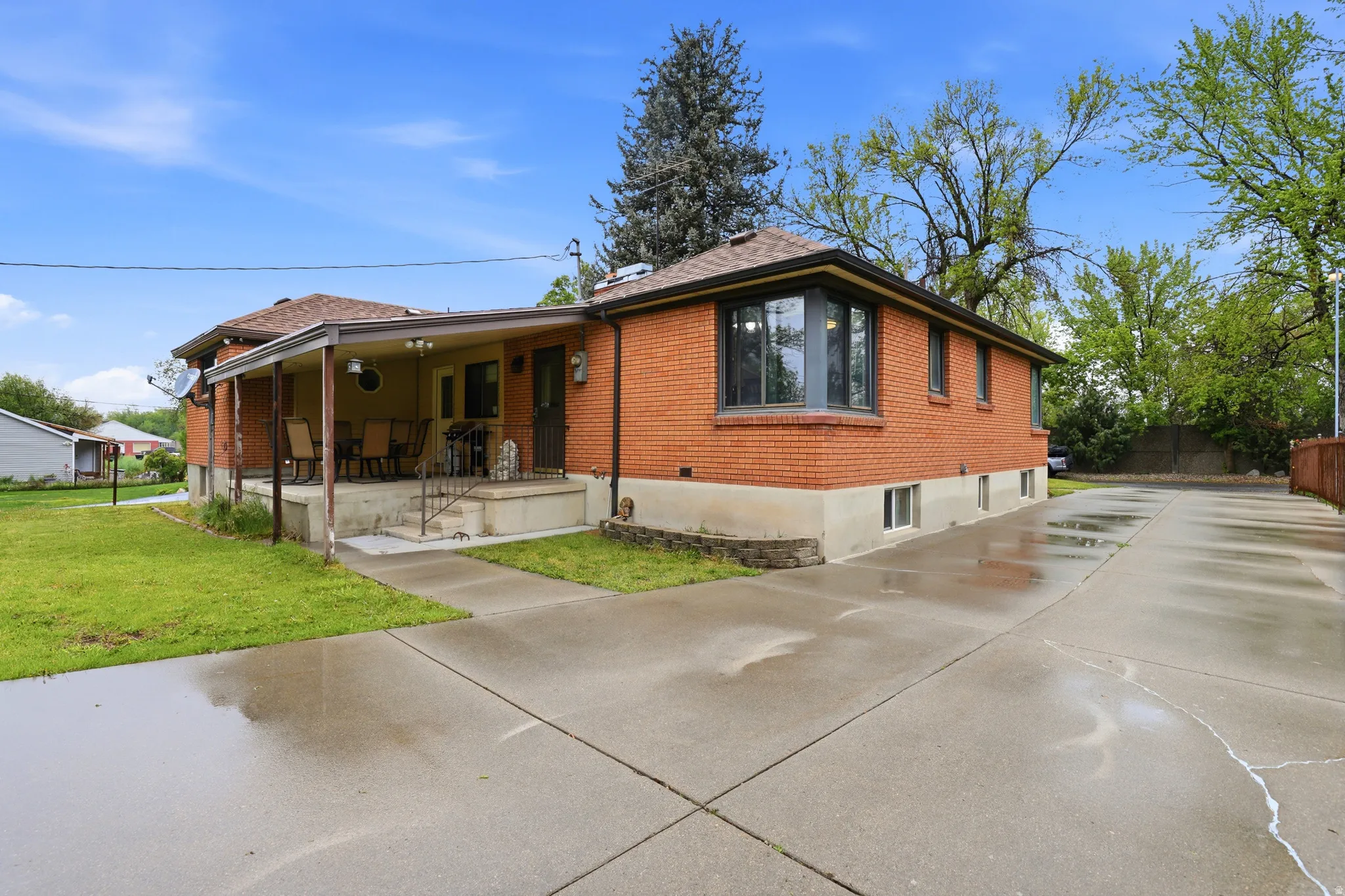 View of front facade with brick siding and concrete driveway