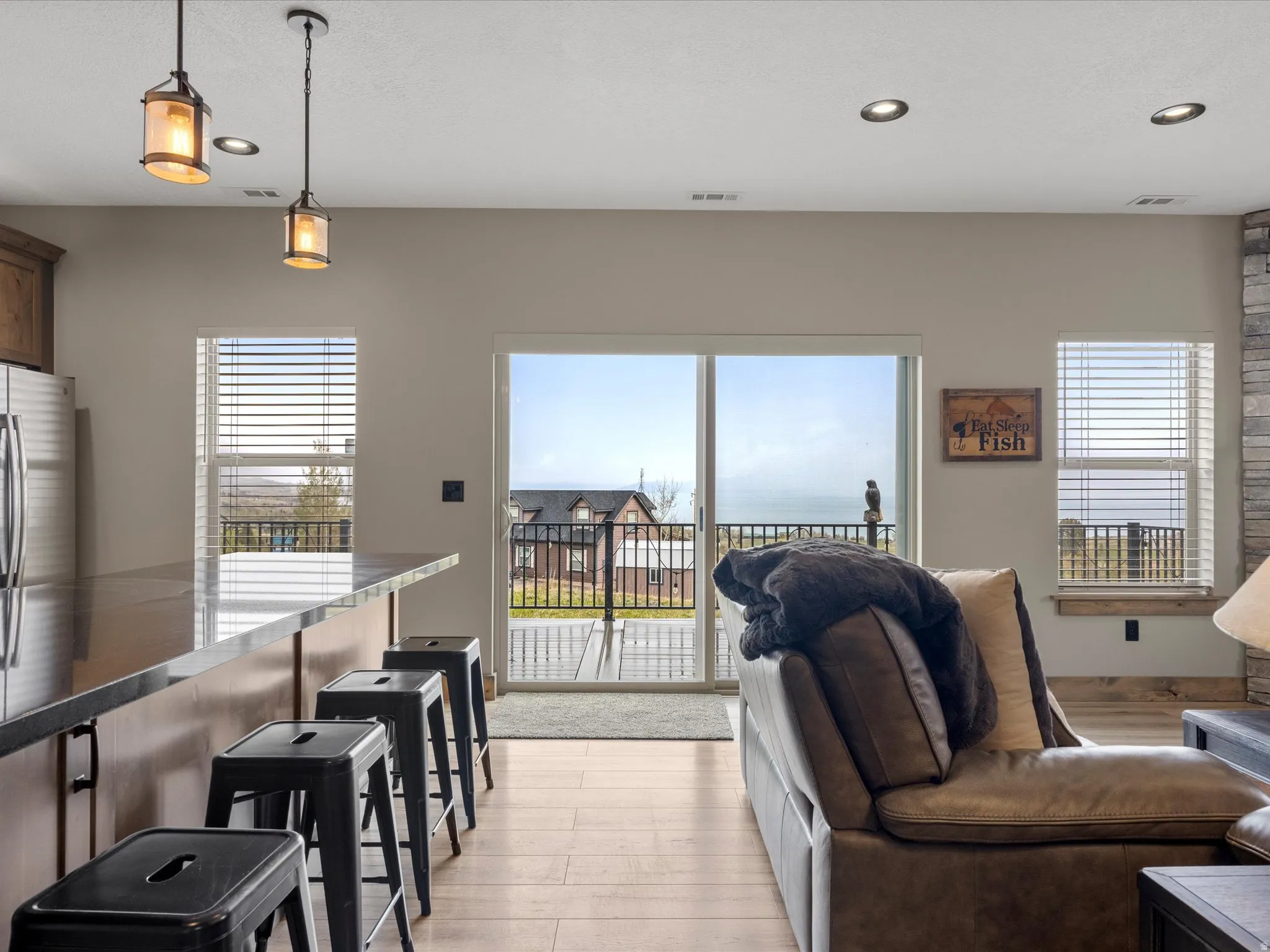 Living area featuring light wood-style flooring, healthy amount of natural light, and recessed lighting