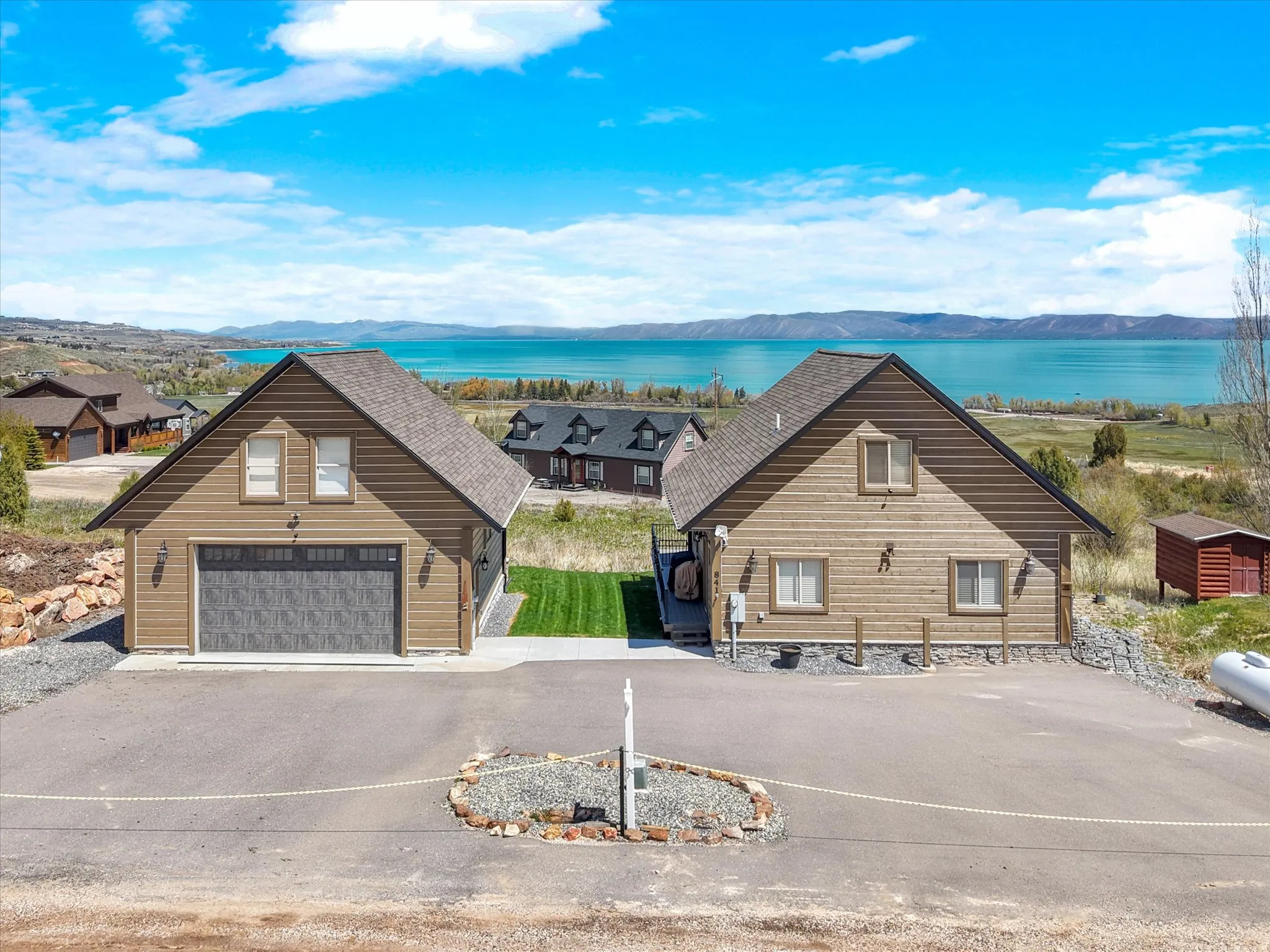 Two distinct structures featuring wood siding and asphalt shingle roofs