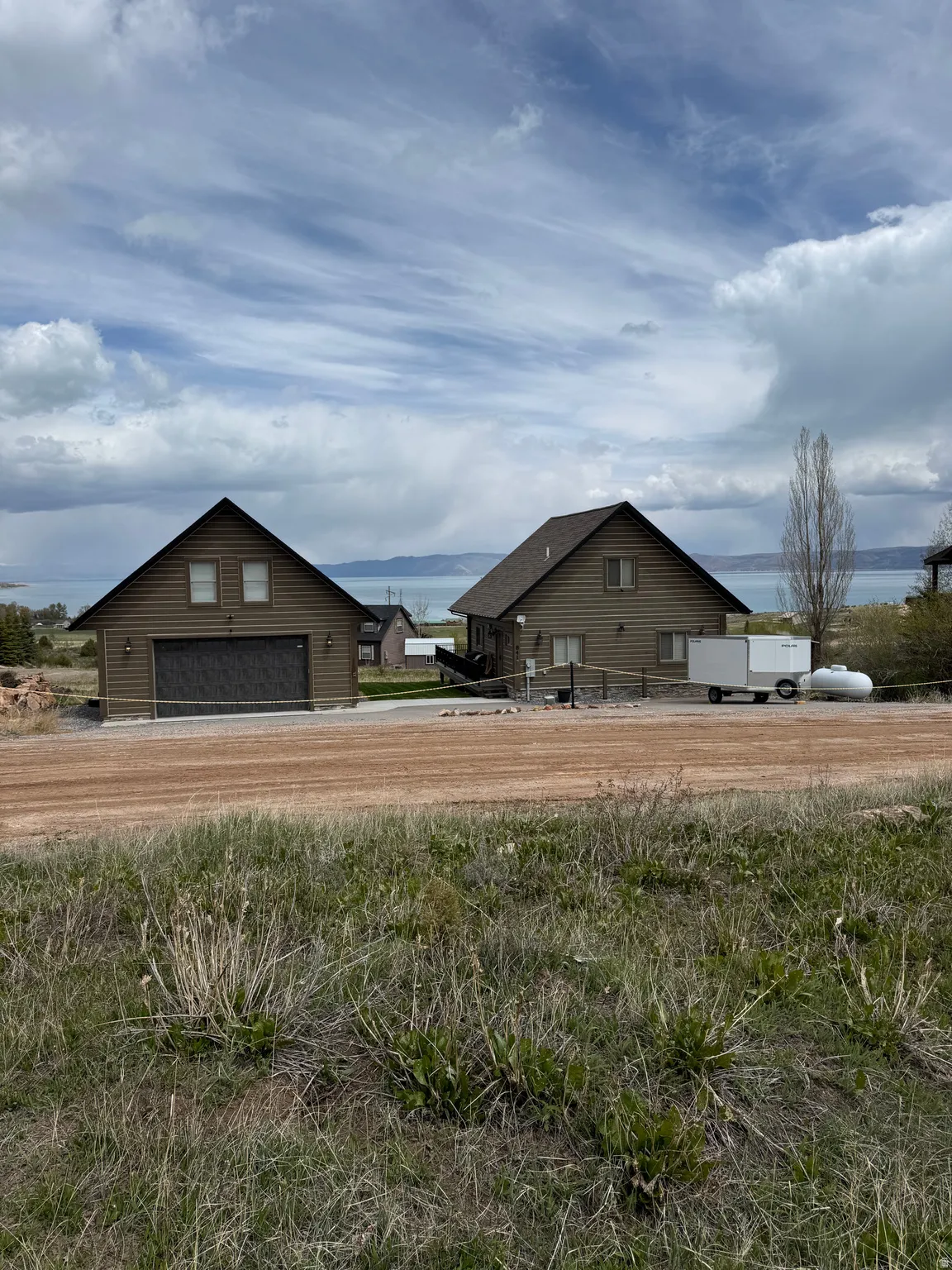 Two brown-sided structures under a cloudy sky