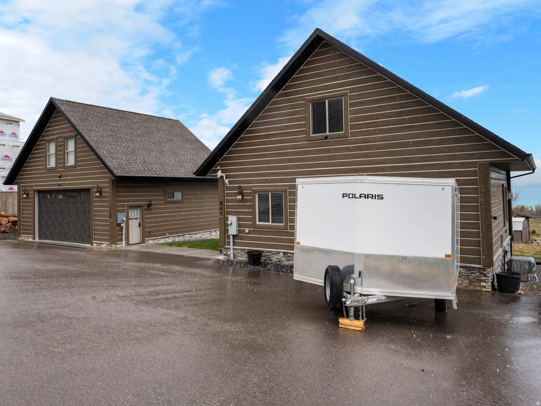 View of side of home with an outbuilding and a garage