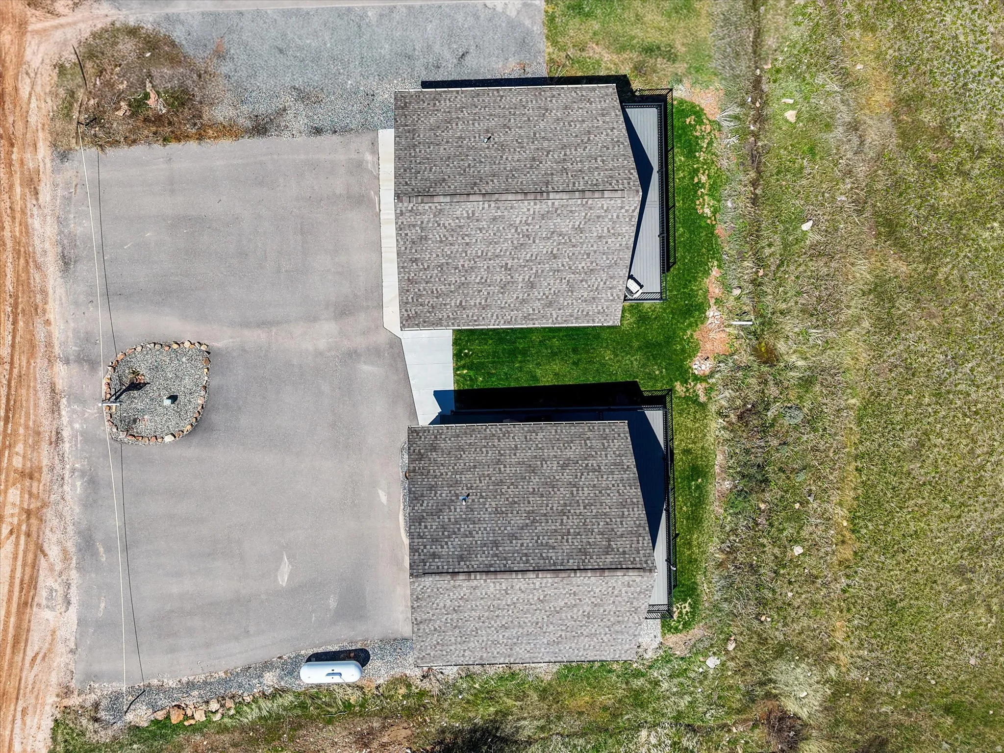Twin structures with shingle roofing and private concrete patios