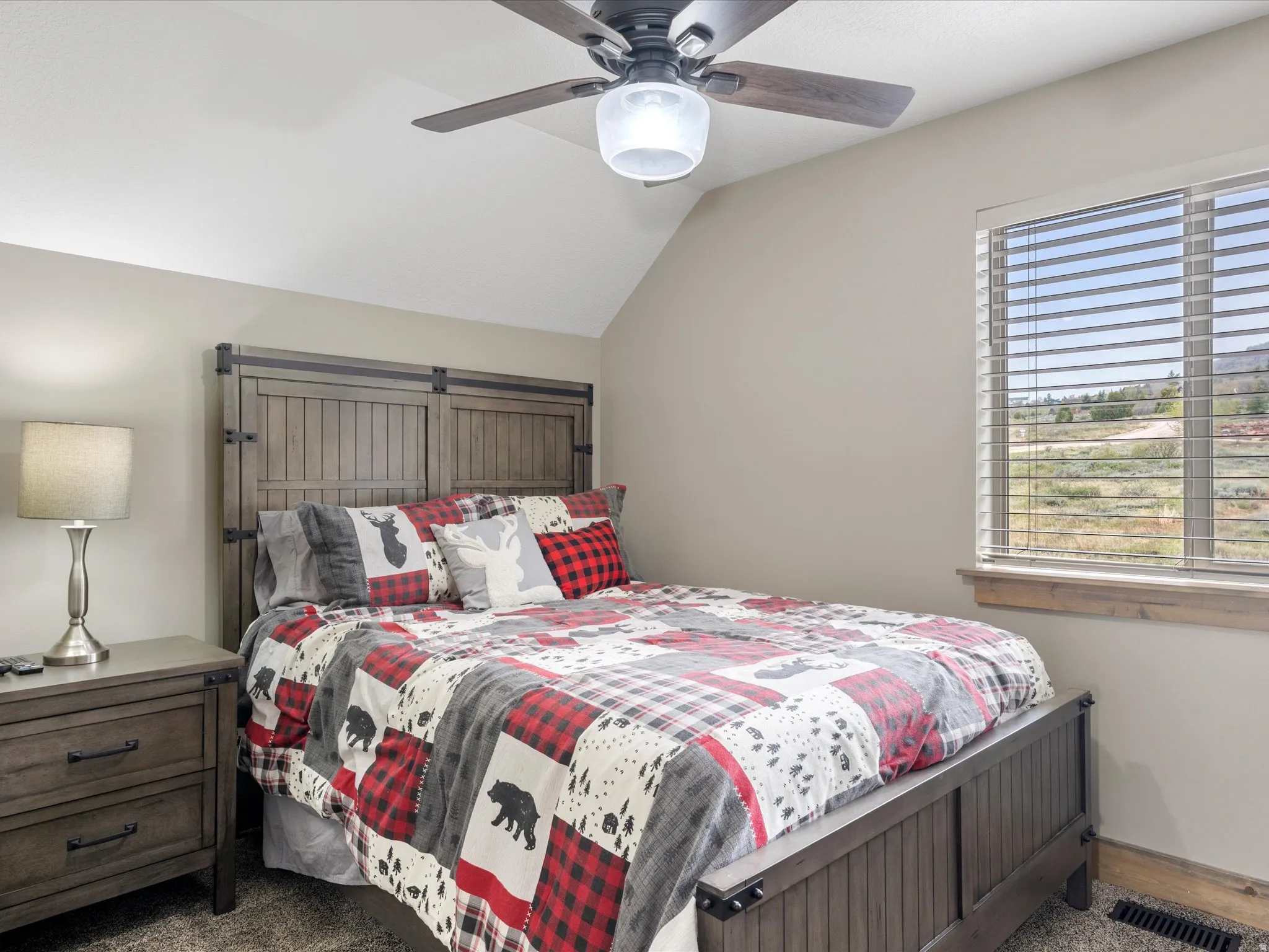 Bedroom with lofted ceiling and ceiling fan