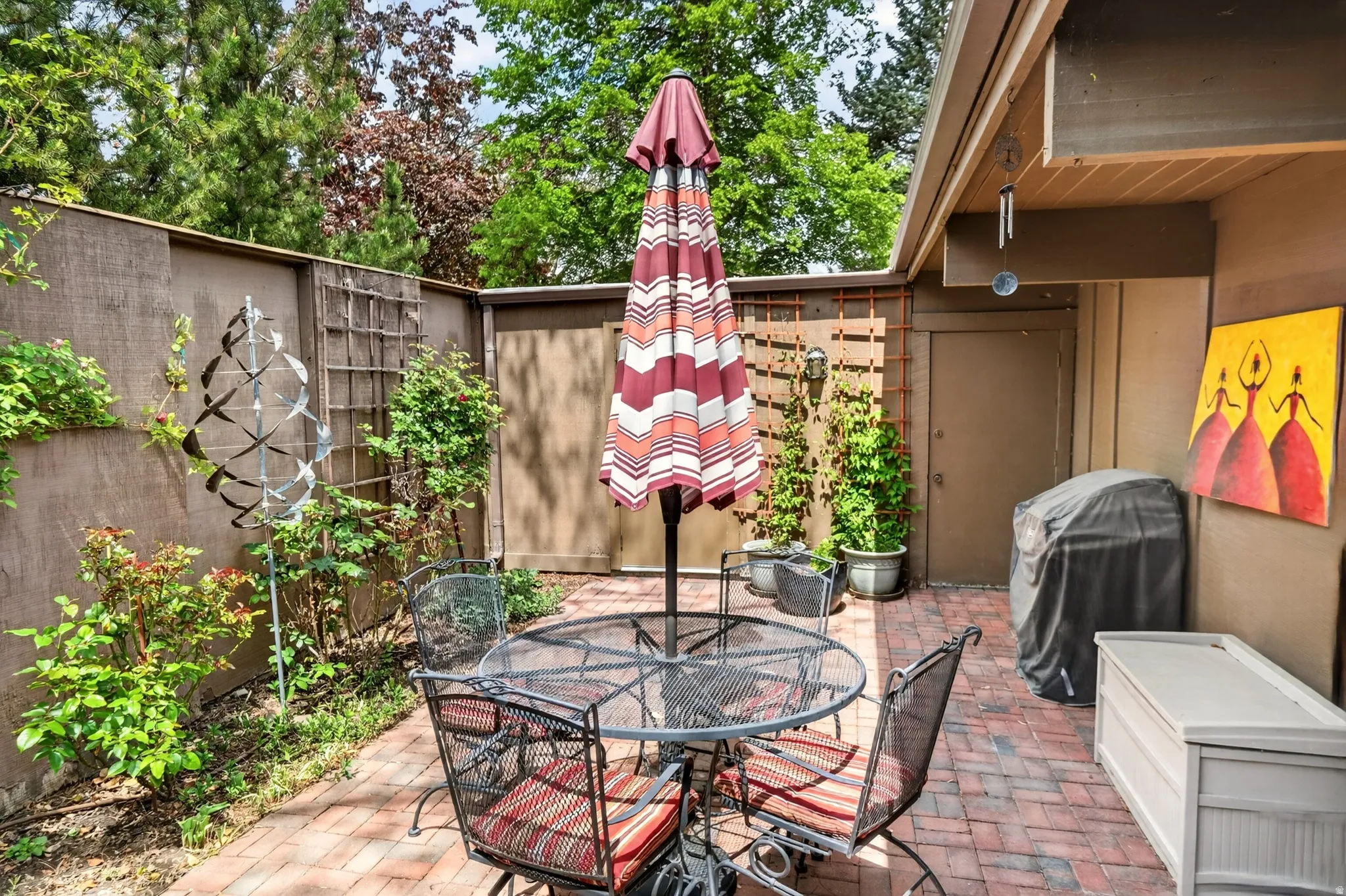 View of patio with outdoor dining space and grilling area
