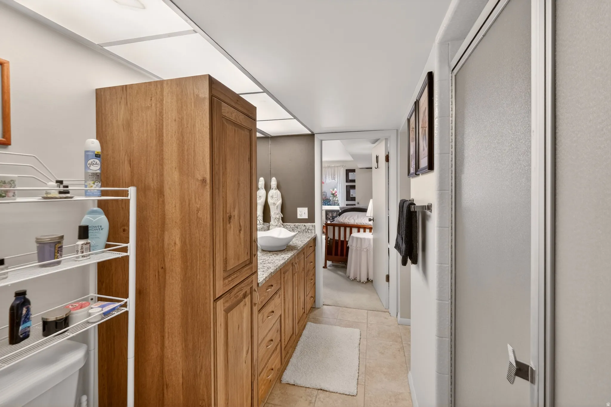 Bathroom with ensuite bathroom, vanity, and a stall shower