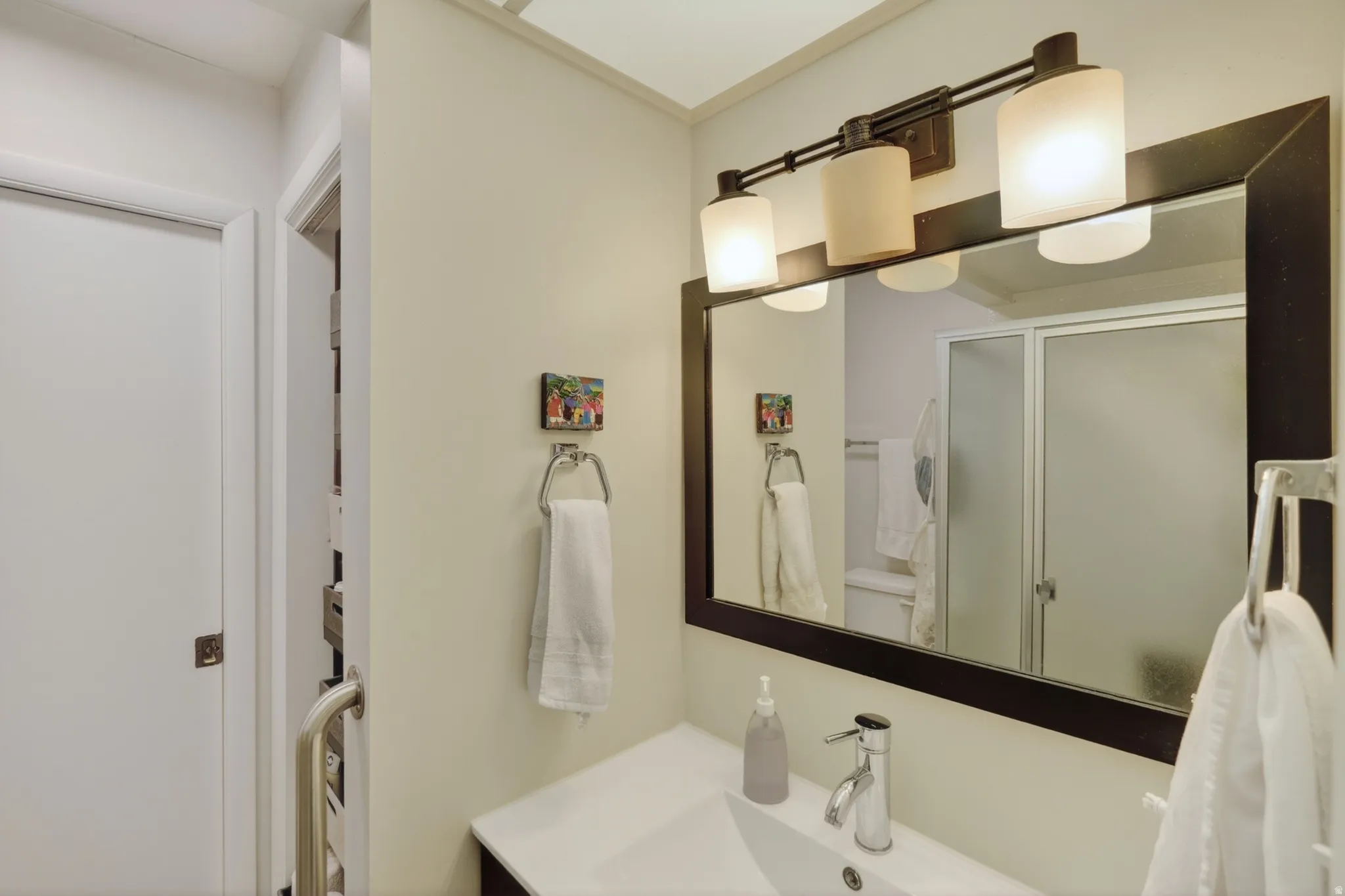 Bathroom featuring a shower stall and vanity