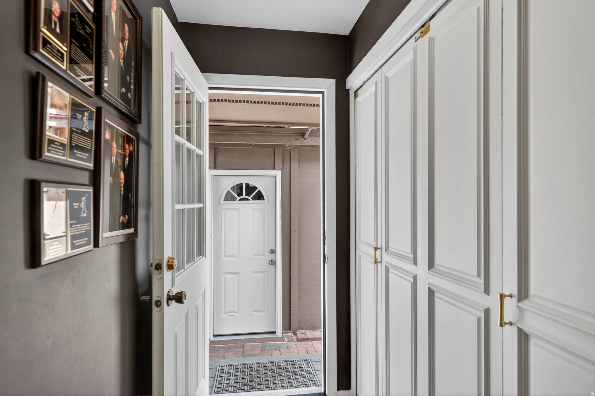 Hall featuring brick patterned floors