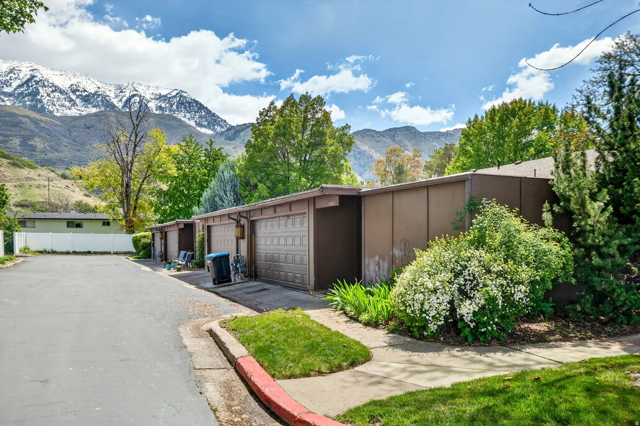 View of side of property with a mountain view and community garages