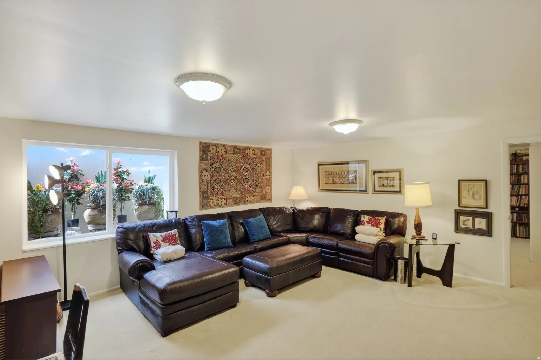 Carpeted living area featuring baseboards