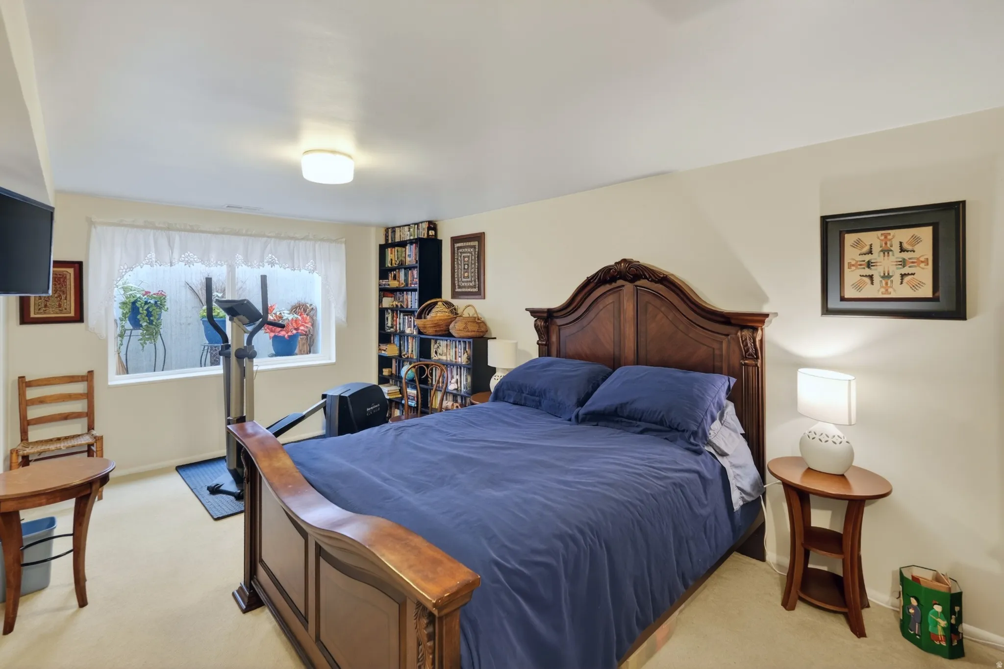 Bedroom featuring light colored carpet and baseboards