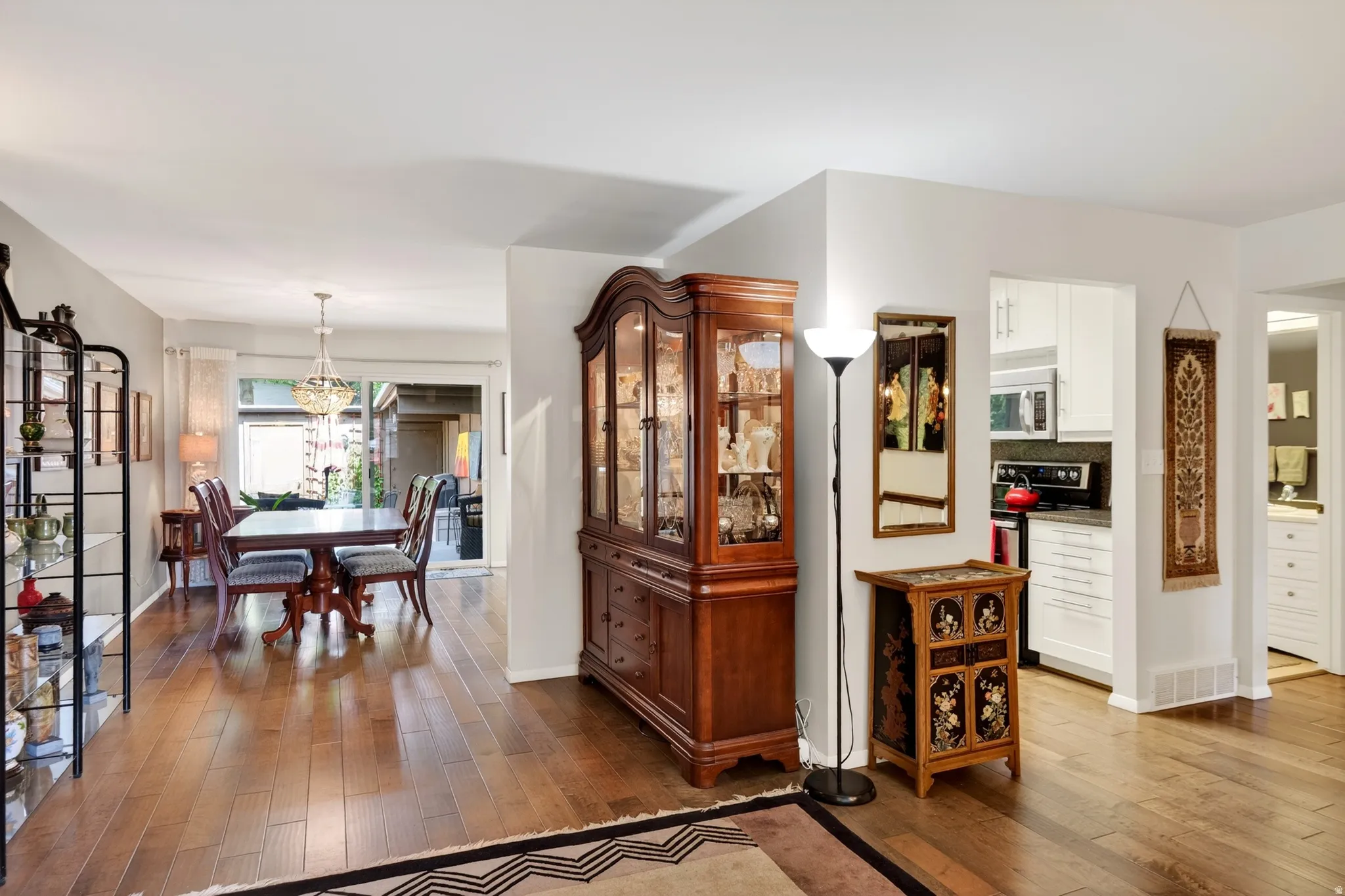 Dining space featuring dark wood finished floors and hanging lights