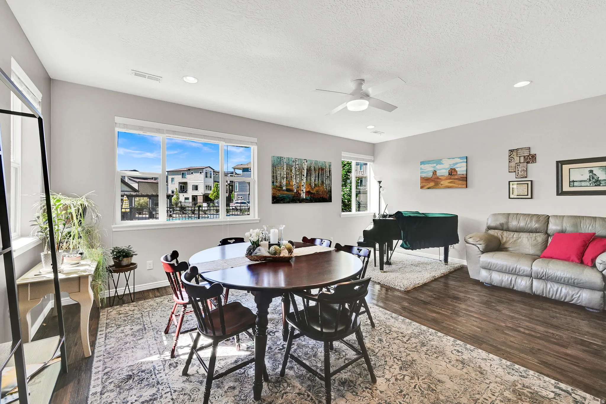 1st floor entrance into this beautiful space that is part exceptional great room. Featuring ceiling fan, dark wood-style flooring, recessed lighting, and a textured ceiling
