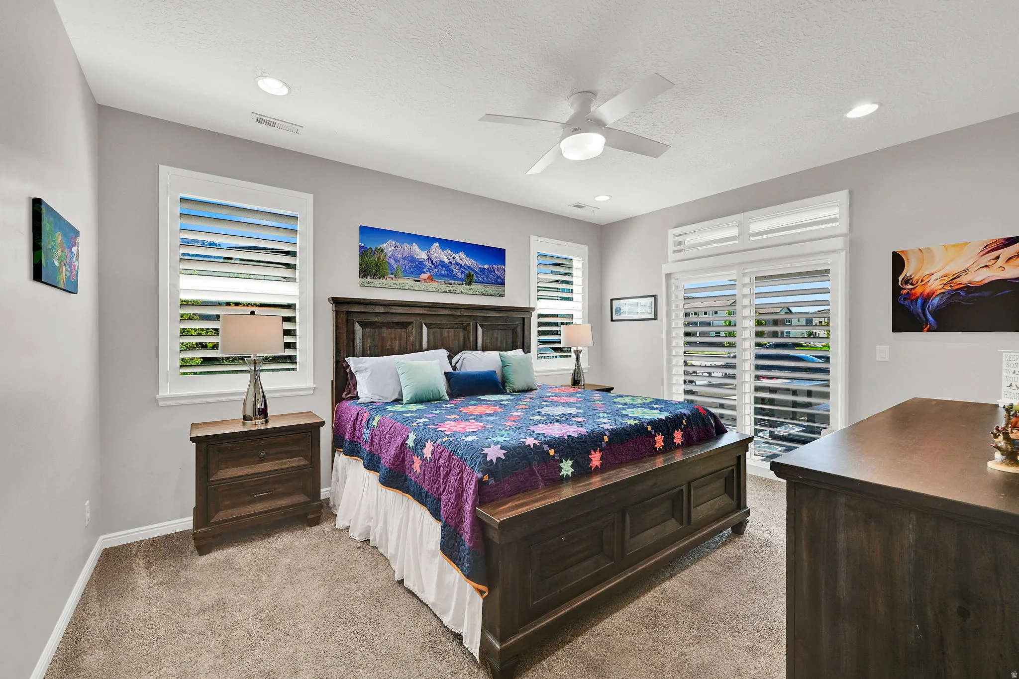 Main level Primary Suite featuring light carpet, ceiling fan, a textured ceiling, and recessed lighting showing the additional entrance from the porch/patio area