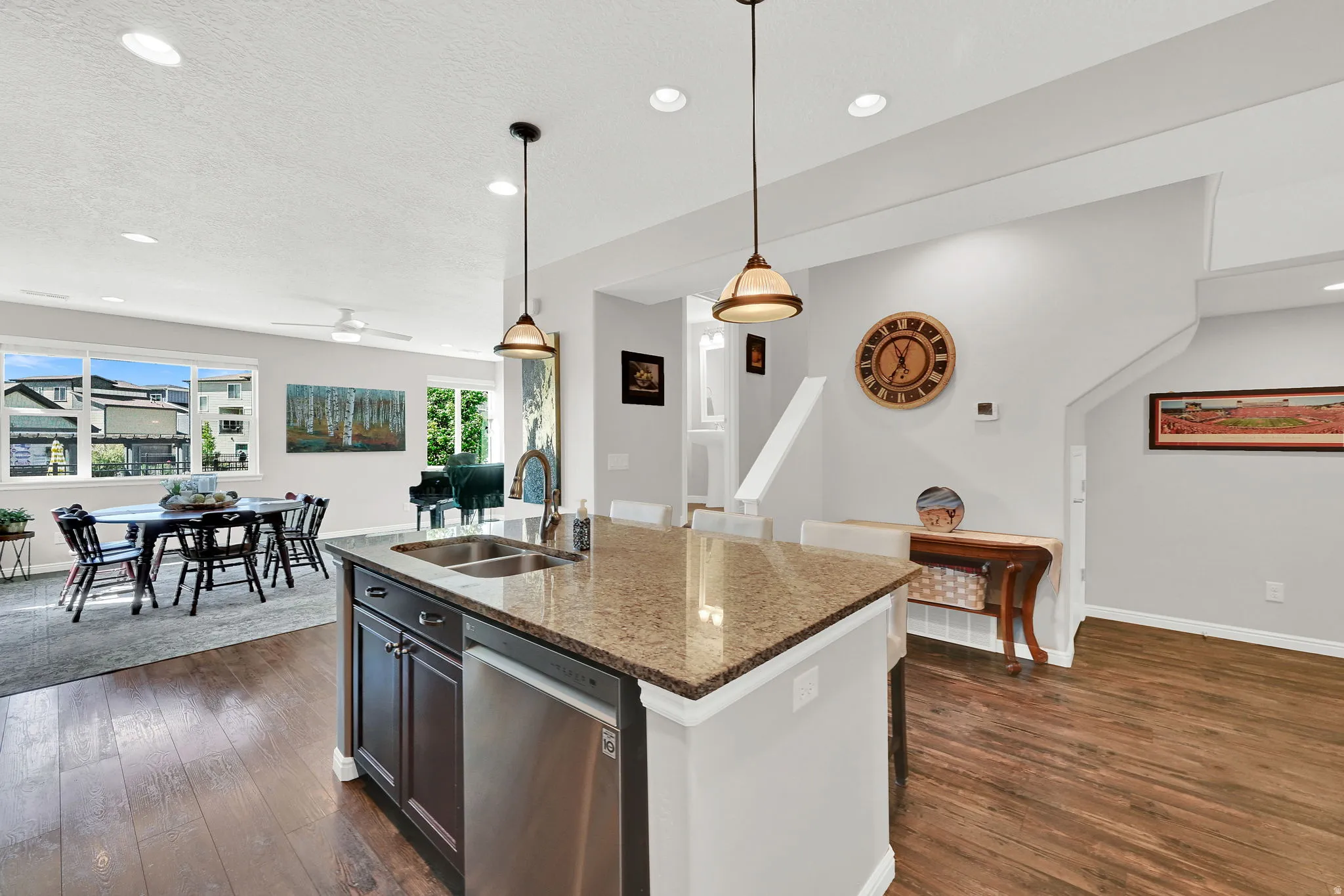 An additional view of the entire great room area, including the kitchen with stainless steel dishwasher