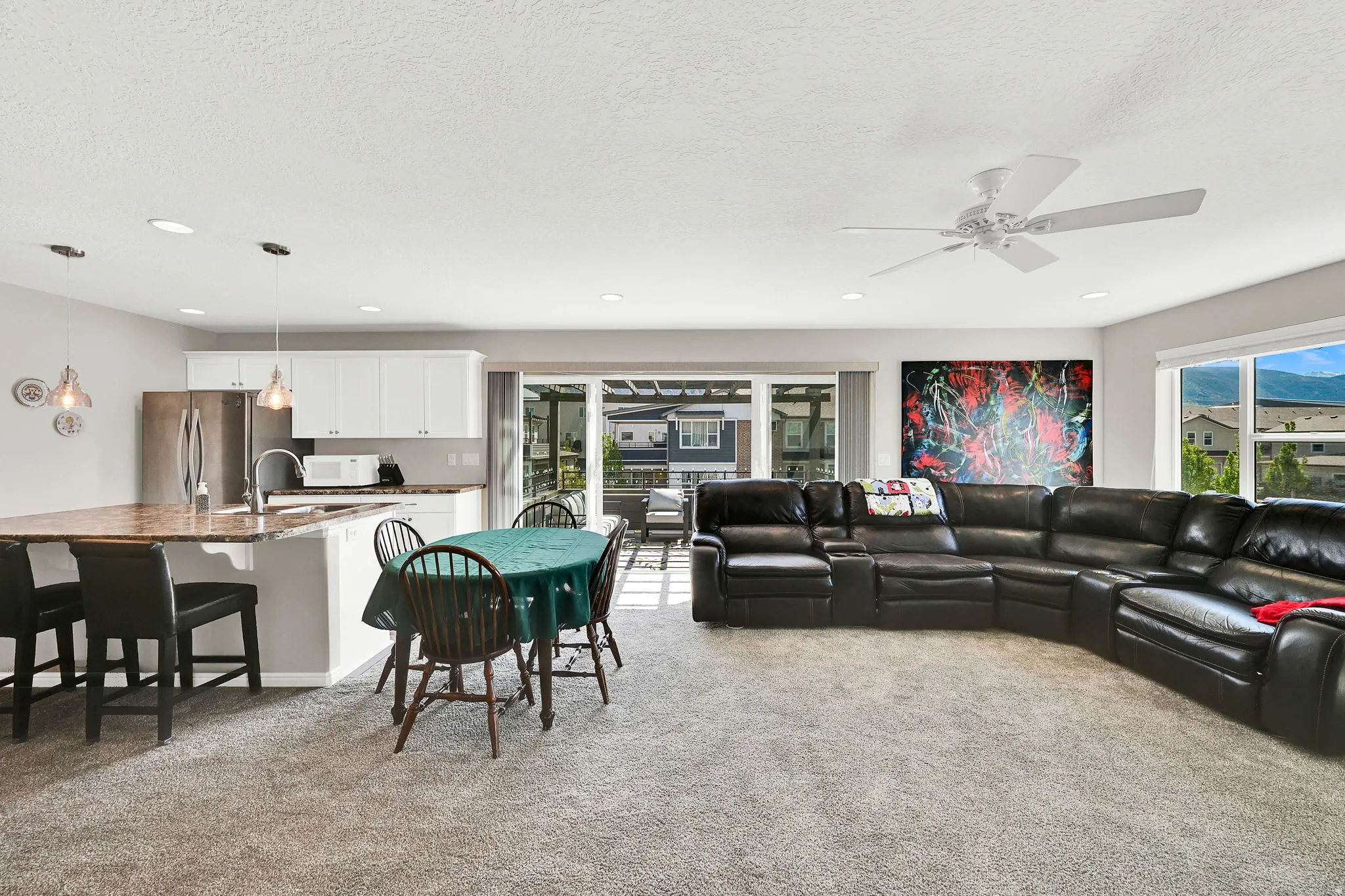 Living area featuring light carpet, healthy amount of natural light
