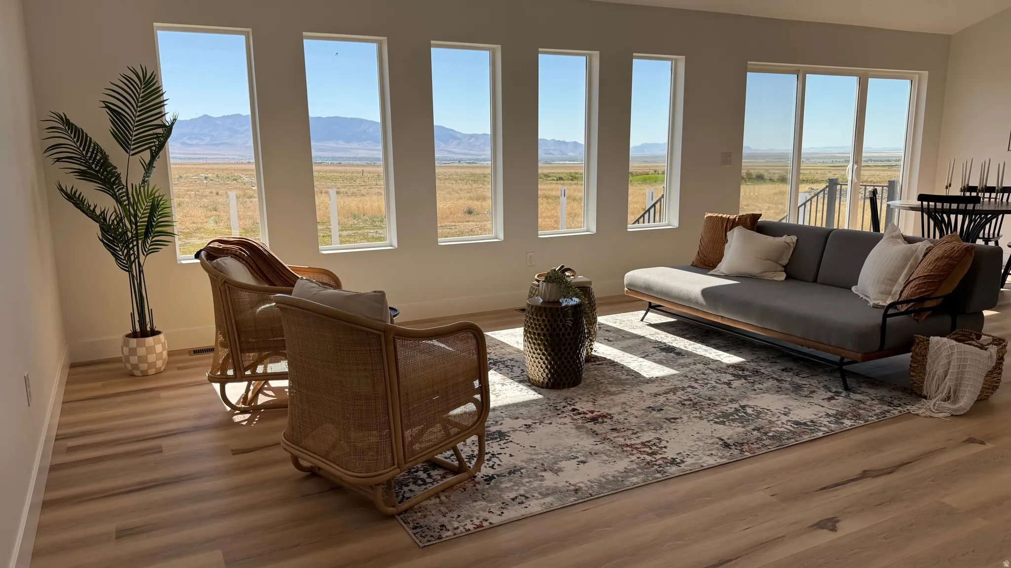 Expansive living area featuring multiple large windows and sliding glass doors, offering abundant natural light and exterior scenery