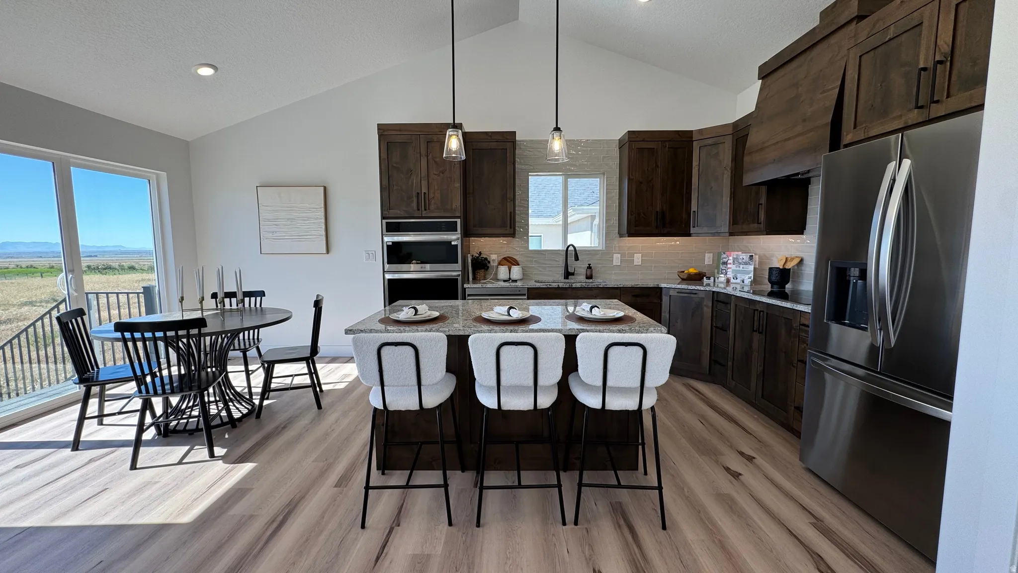 Open-concept kitchen and dining area with vaulted ceilings