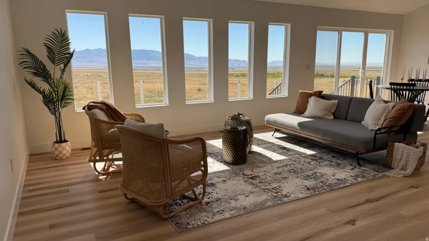 Expansive living area featuring multiple large windows and sliding glass doors, offering abundant natural light and exterior scenery