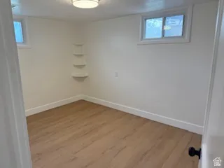 Basement featuring wood finished floors and baseboards