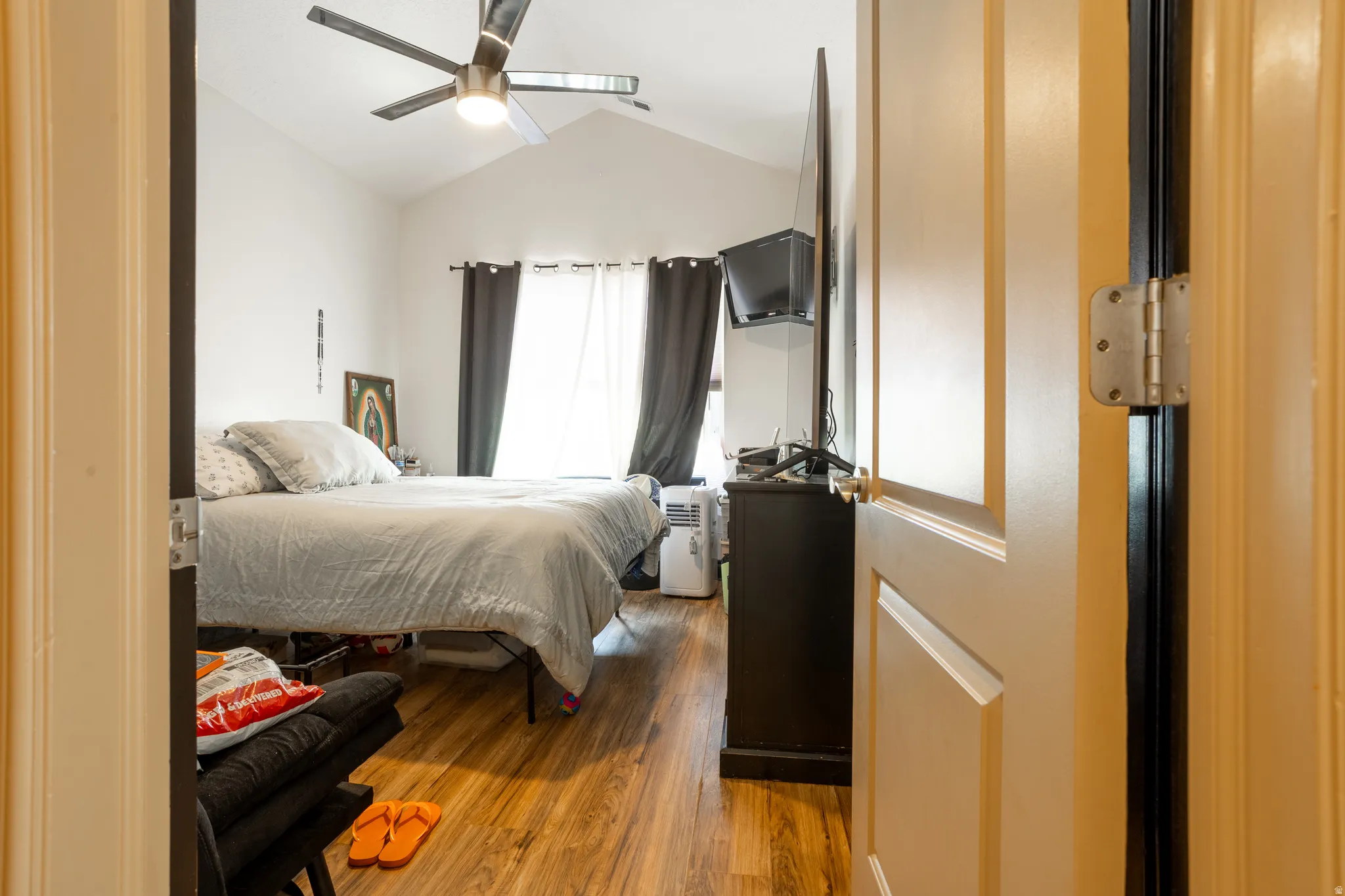 Bedroom featuring wood finished floors and ceiling fan