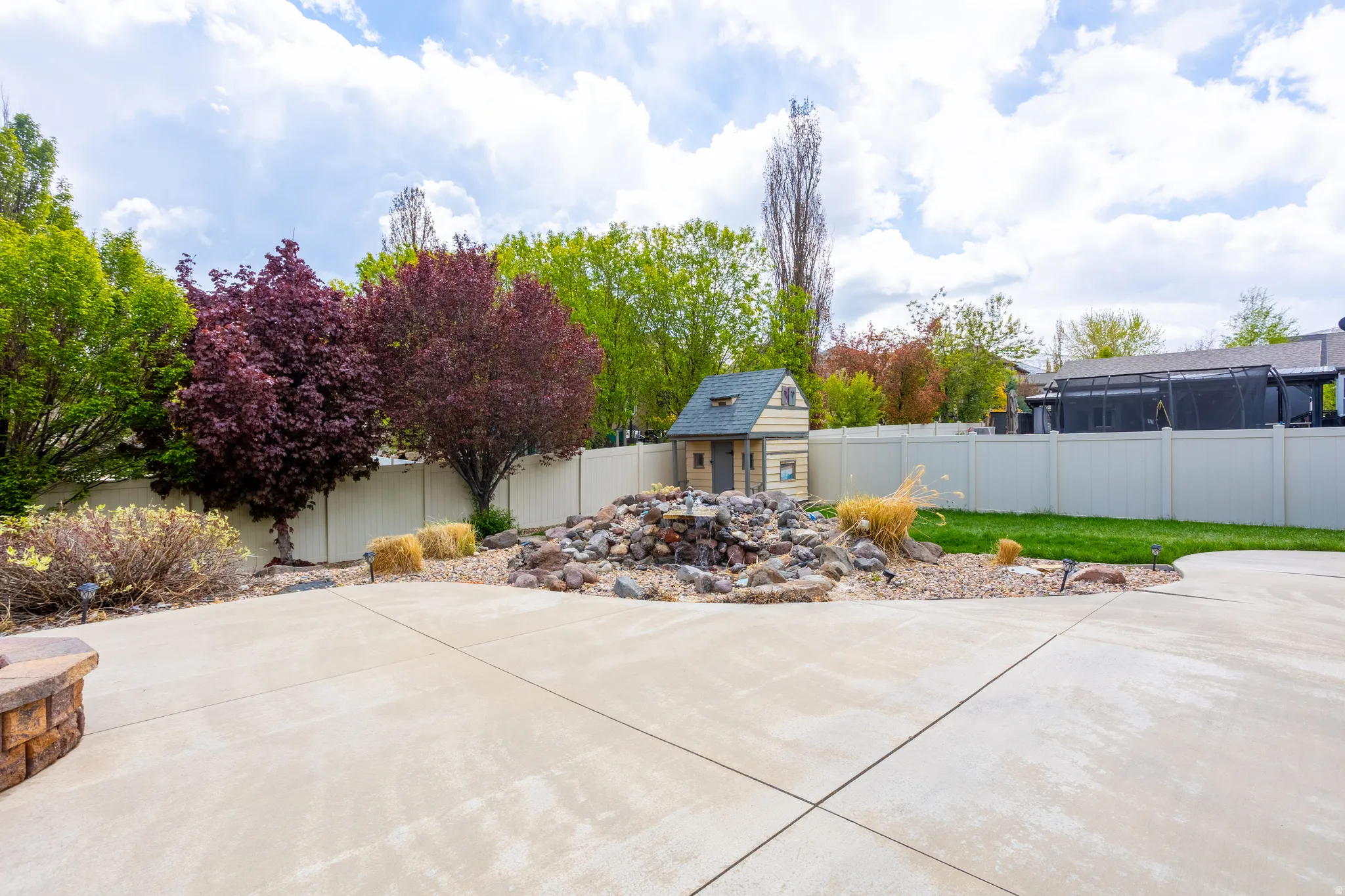 Fenced backyard with an outbuilding