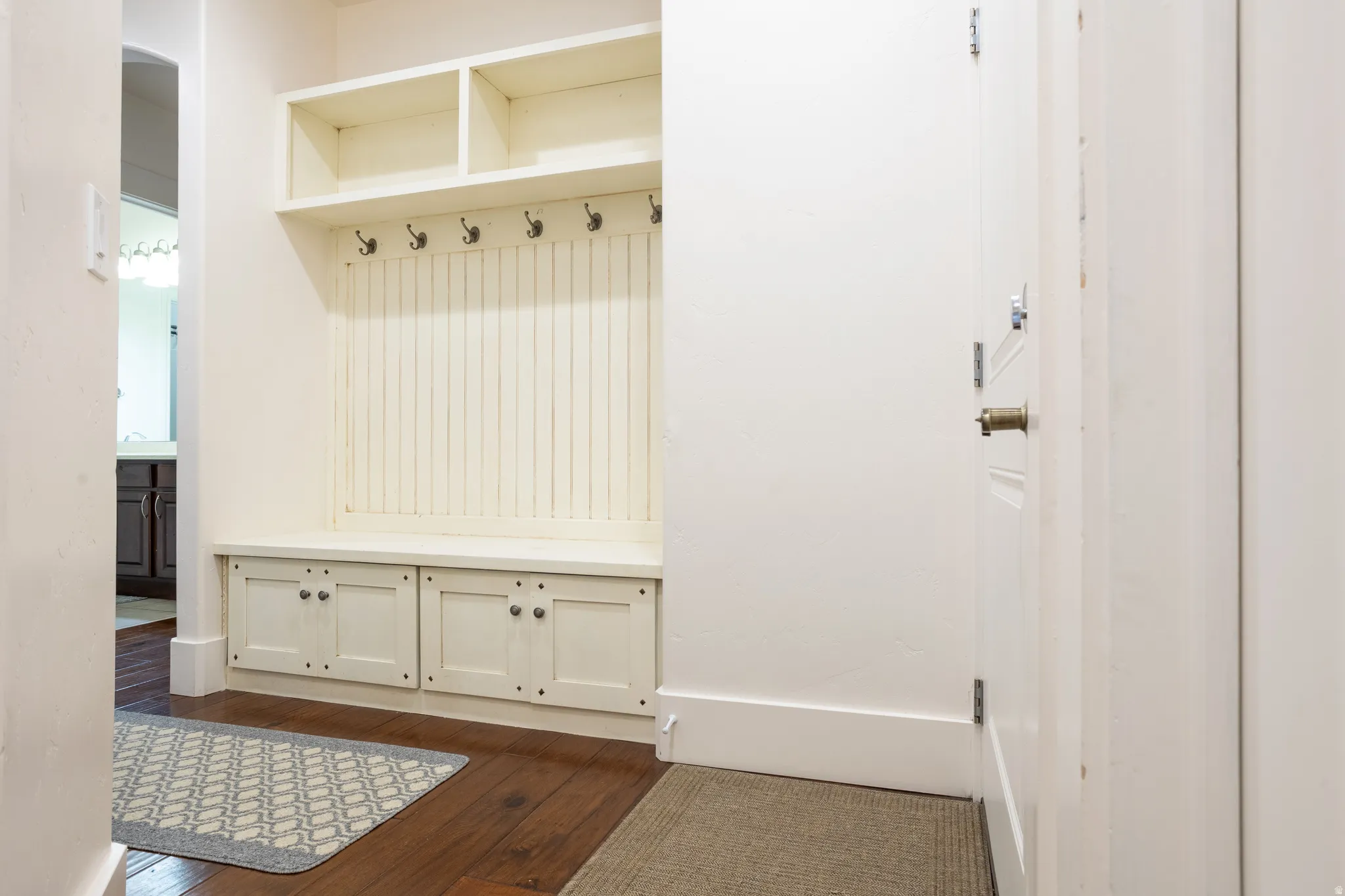 Mudroom with dark wood finished floors