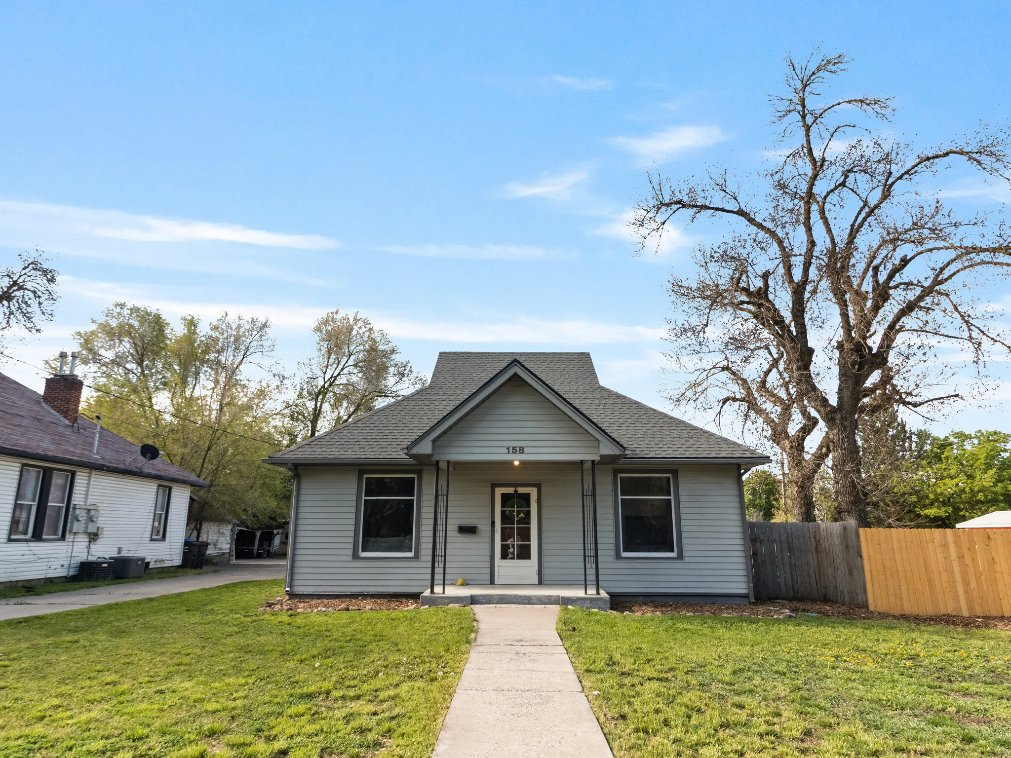 Bungalow-style house featuring covered porch and a shingled roof