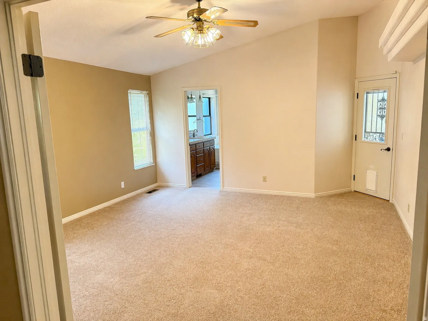 Unfurnished room with light carpet, ceiling fan, and lofted ceiling